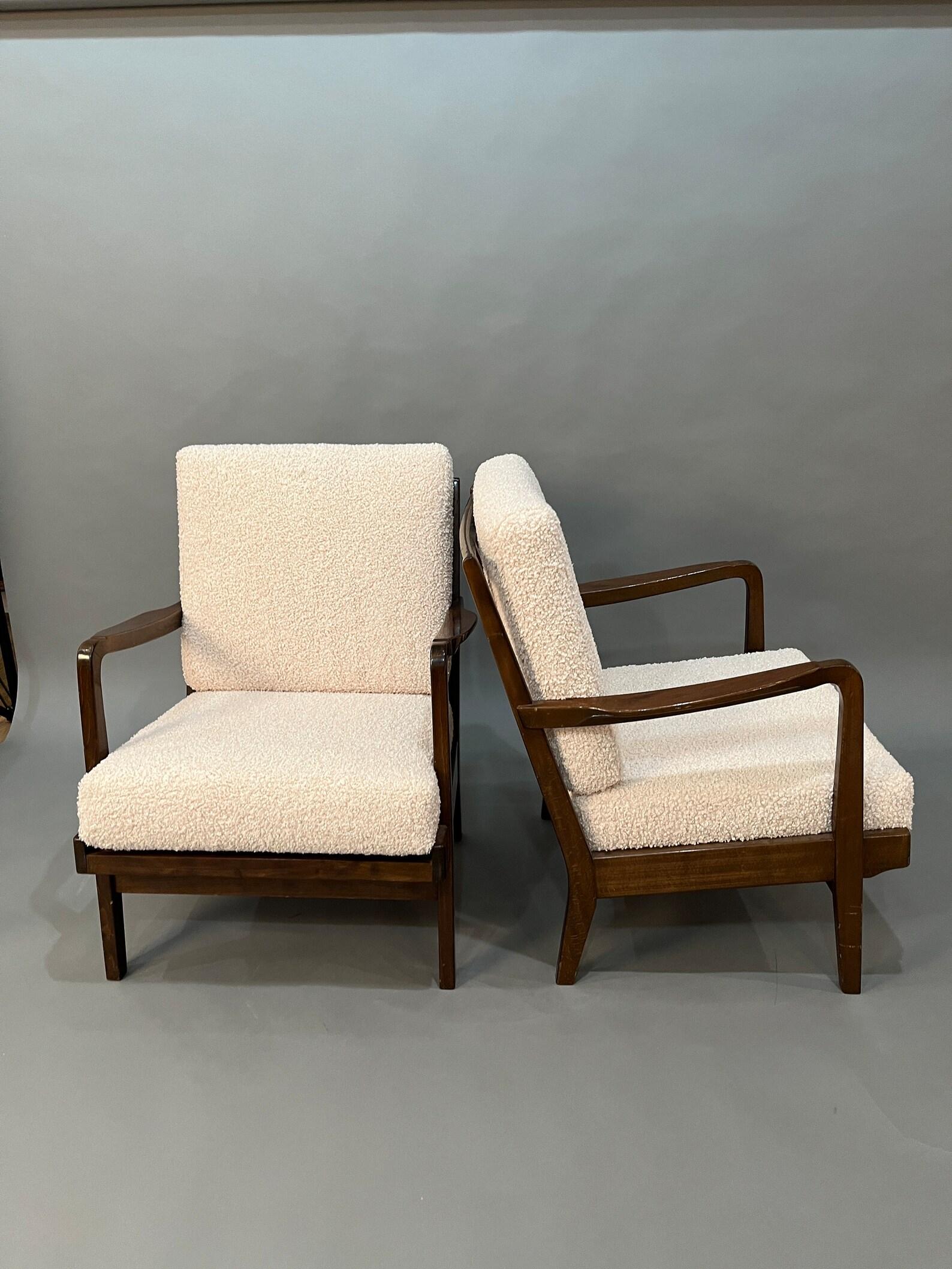 Discover our meticulously selected pair of exquisite Mid Century mahogany lounge chairs, thoughtfully curated to enhance your living space. Each chair is adorned with brand new Fuzzy Bouclee cream cushions and inner firm foam, Adding a touch of
