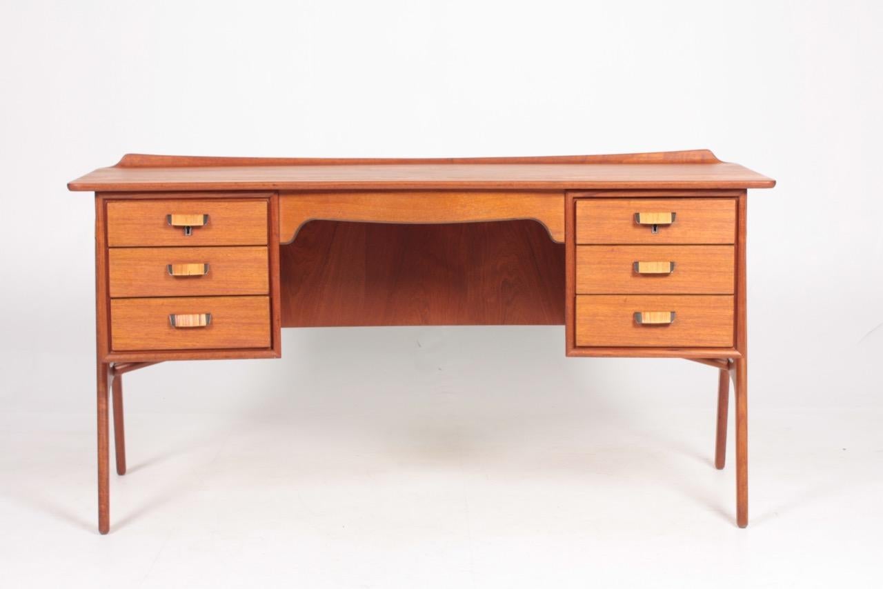 Great looking desk in teak with cane details on the frame and the handles. Designed by Svend Aage Madsen. Made in Denmark in the 1950s. Nice original condition.