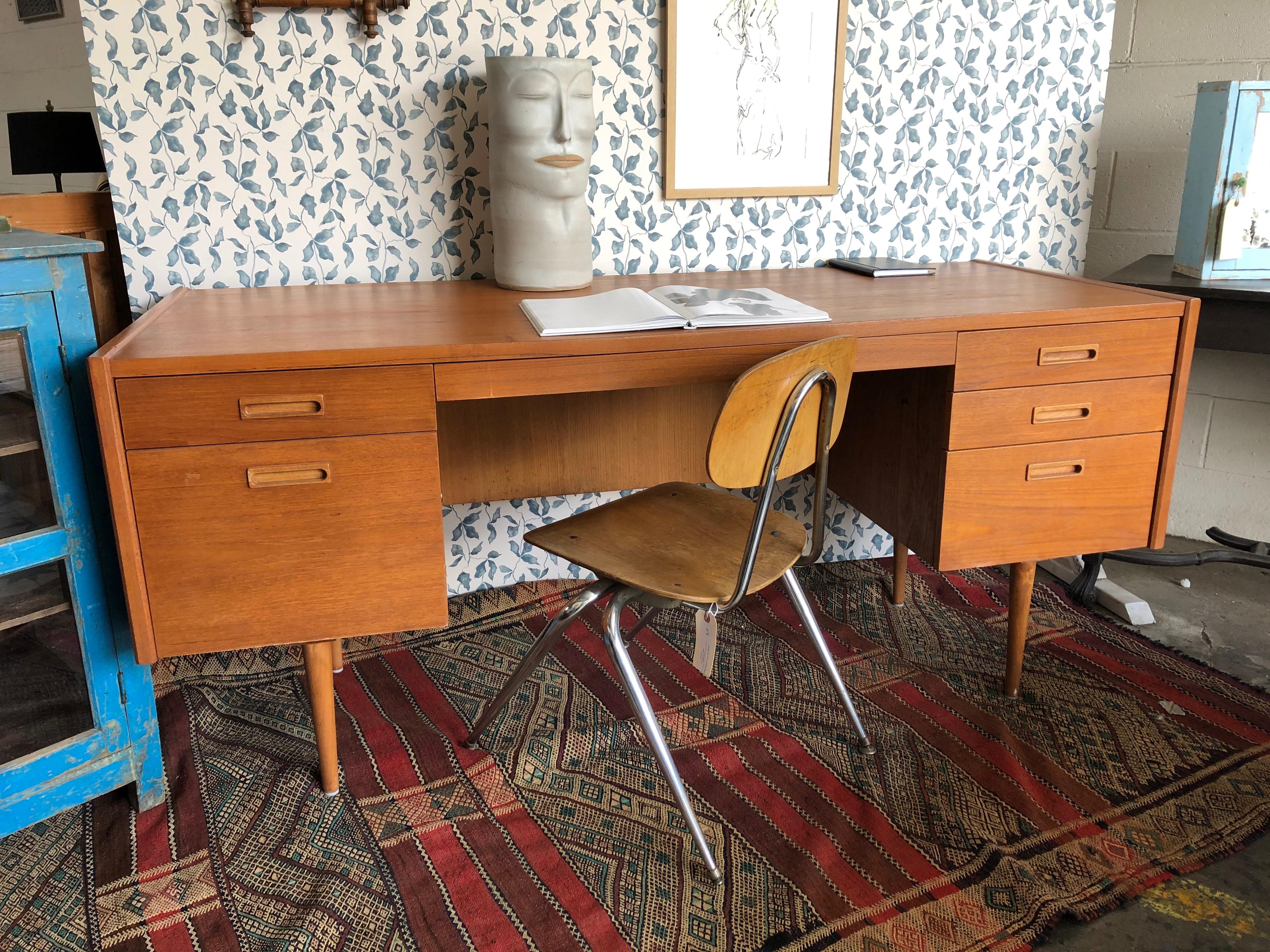 This mid century desk features draws that slide out and sleek peg legs. Perfect for a study or at-home office. 

Our vintage pieces have been thoughtfully selected for their incredible craftsmanship and unique character that will compliment any
