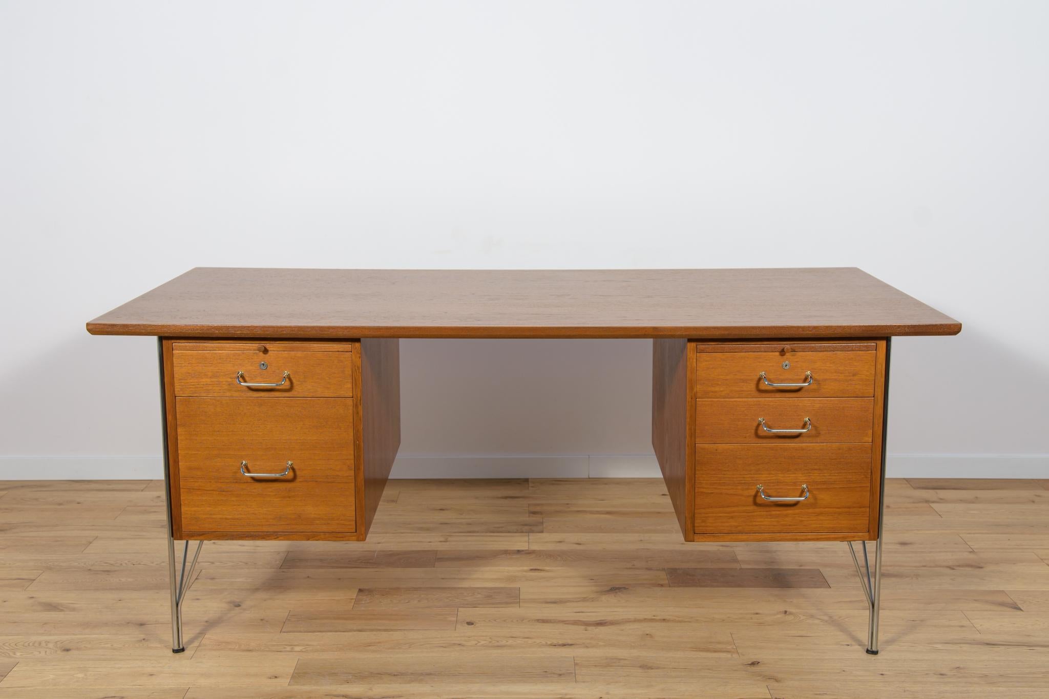 
The desk designed by Heinrich Roepstorff, produced in Denmark in the 1970s. The desk has a large worktop. There are two modules in the desk, on the right there are 3 drawers, on the right there is a drawer and a large drawers on briefcas. Each