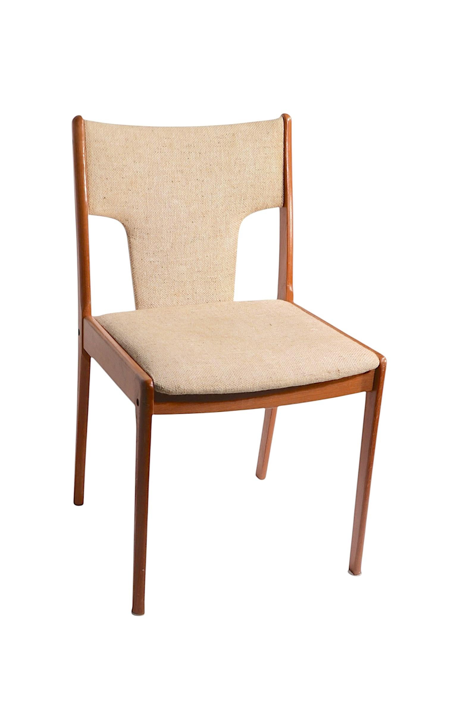 Elegante mesa de comedor de estilo danés de mediados de siglo, con estructura de madera de teca y asiento y respaldo tapizados en tweed. Este ejemplar es estructuralmente sólido y robusto, el tapizado está en estado regular , utilizable, mostrando