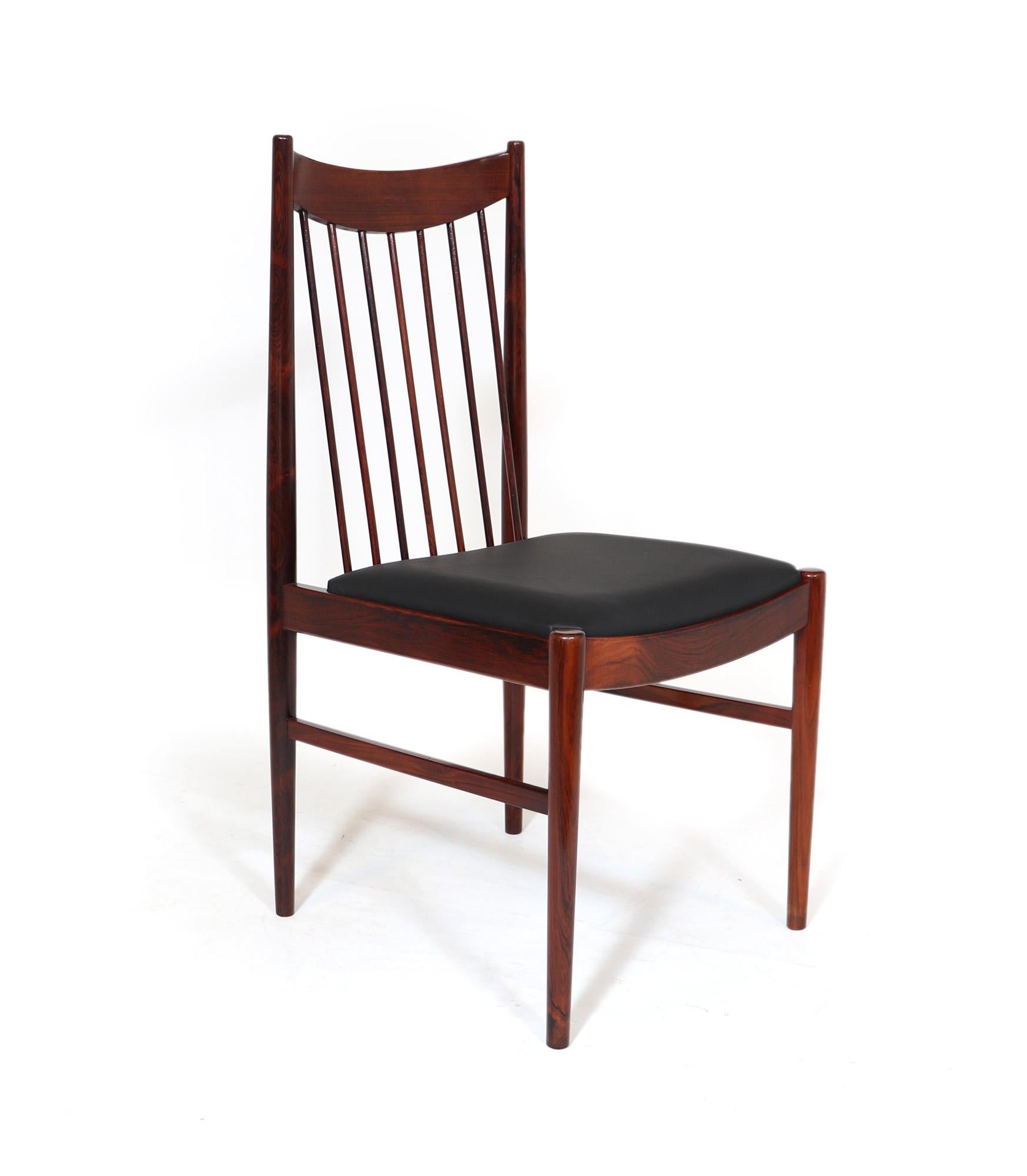 A set of four model 442 dining chairs designed by Arne Vodder and produced by Sibast in Denmark in the early 1960s the frame is partly solid rosewood and have newly upholstered black leather seat covers, the chairs have been fully polished and are