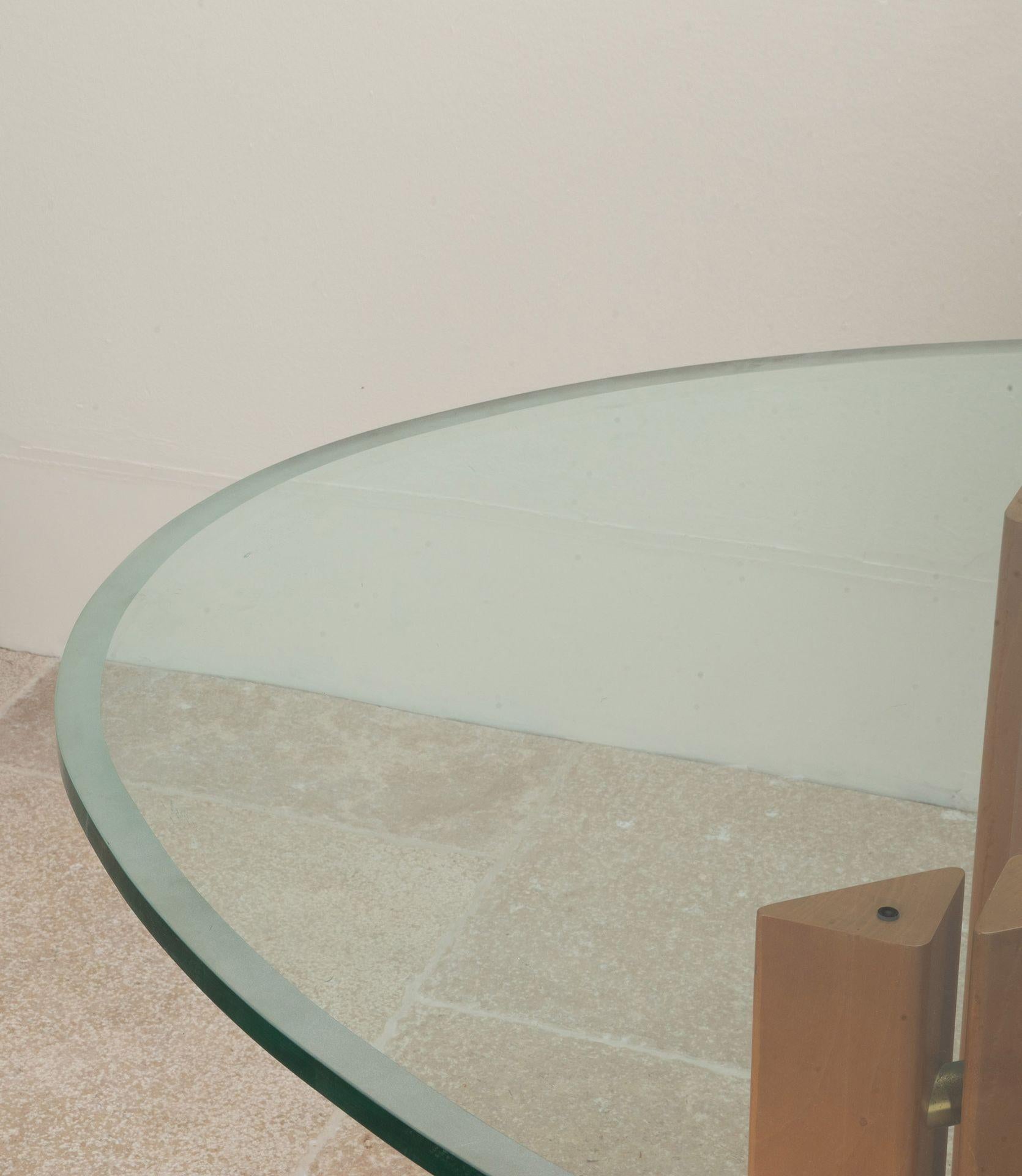 Elegant Mid-Century Danish dining table.
With wooden legs which can be placed in different ways and a thick glass top.
Circa 1980.