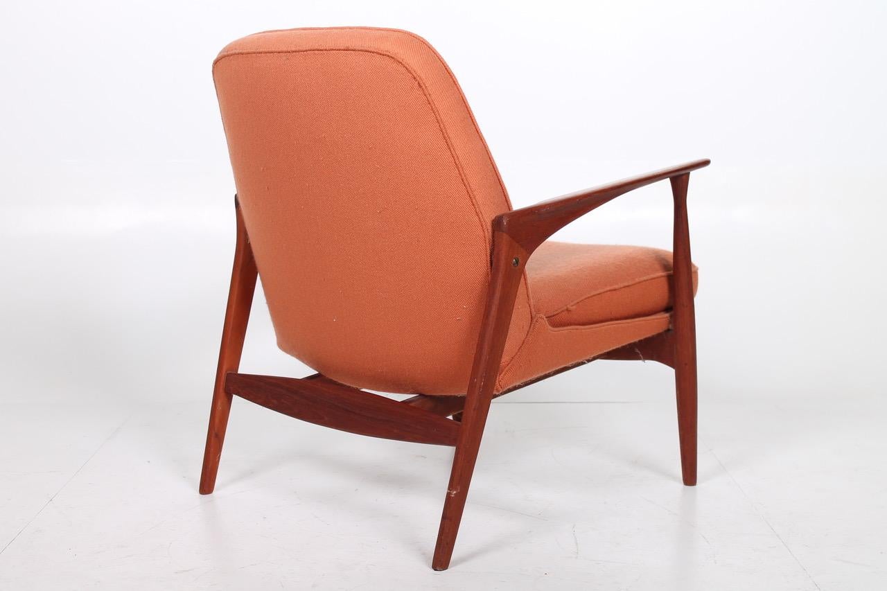 Easy chair in teak and fabric. Model 401 designed in 1956 by Ib Kofod-Larsen and produced by Slagelse Møbelværk.