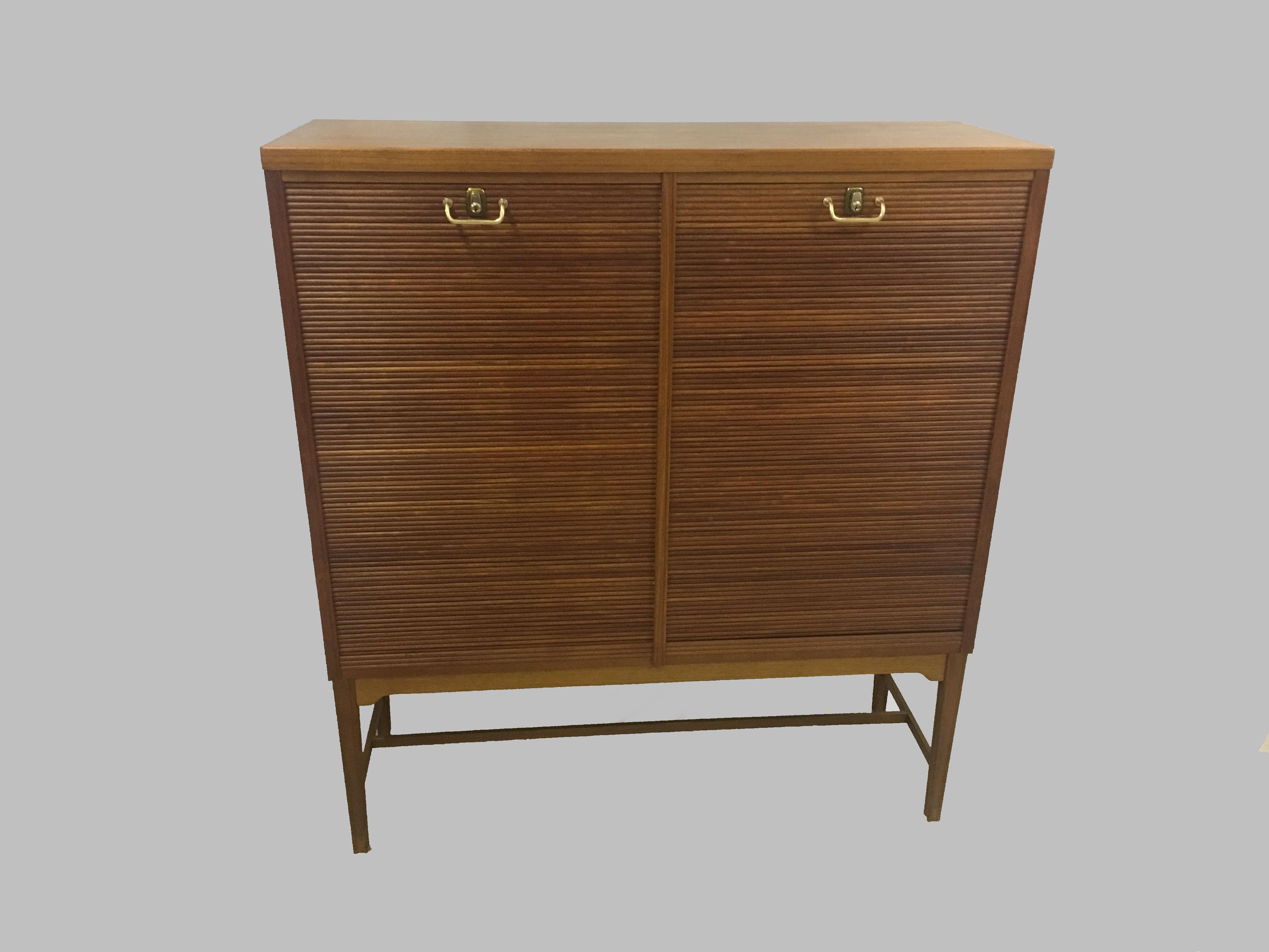 Midcentury Danish executive teak cabinet from the 1950s-1960s

The well and elegant designed spacious teak cabinet bear witness of exquisite craftsmanship with lots of small details in the woodwork making what could just be a heavy traditional