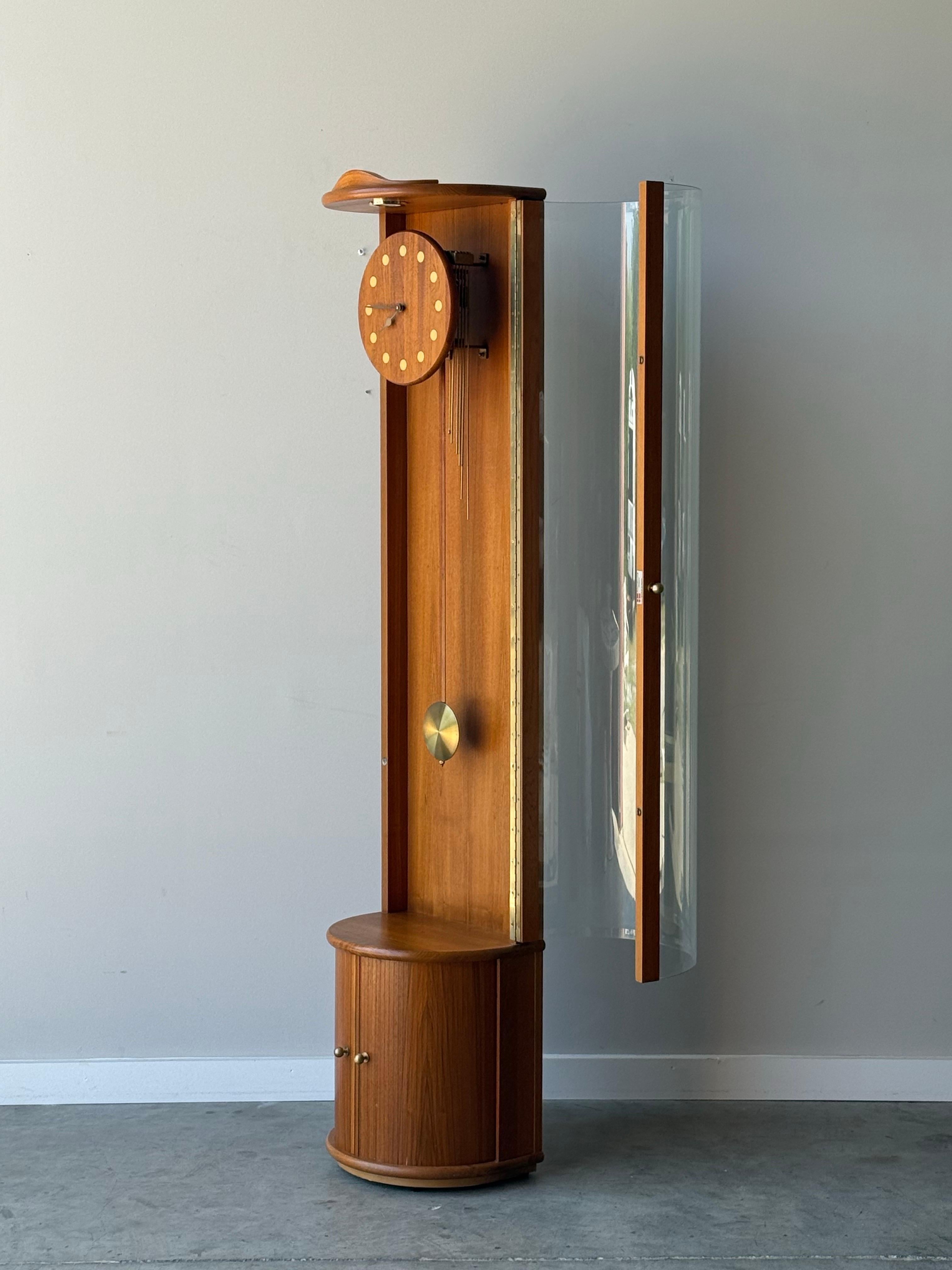 The first grandfather clock we have ever offered and it’s perfectly mid-century. Designed and made circa 1960s, Denmark. The frame is made from teak wood and featuring a tambour door at the bottom that opens to a spacious storage compartment. Brass
