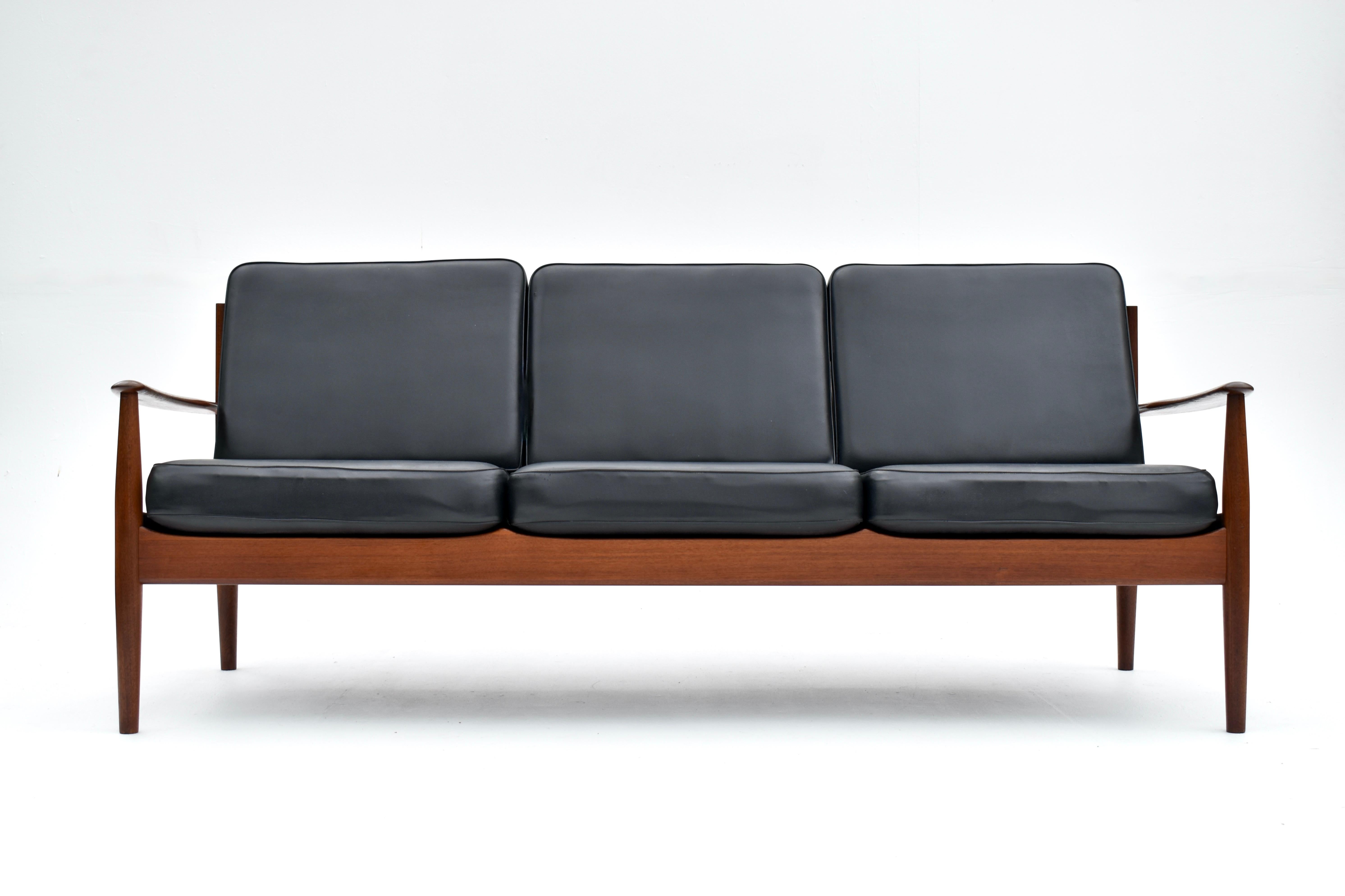 A Danish design classic from Grete Jalk. A solid Teak frame sofa that is full of sculptural appeal and wonderful attention to detail. We took some images of the frame without the cushions to fully appreciate the form of this design. We particularly
