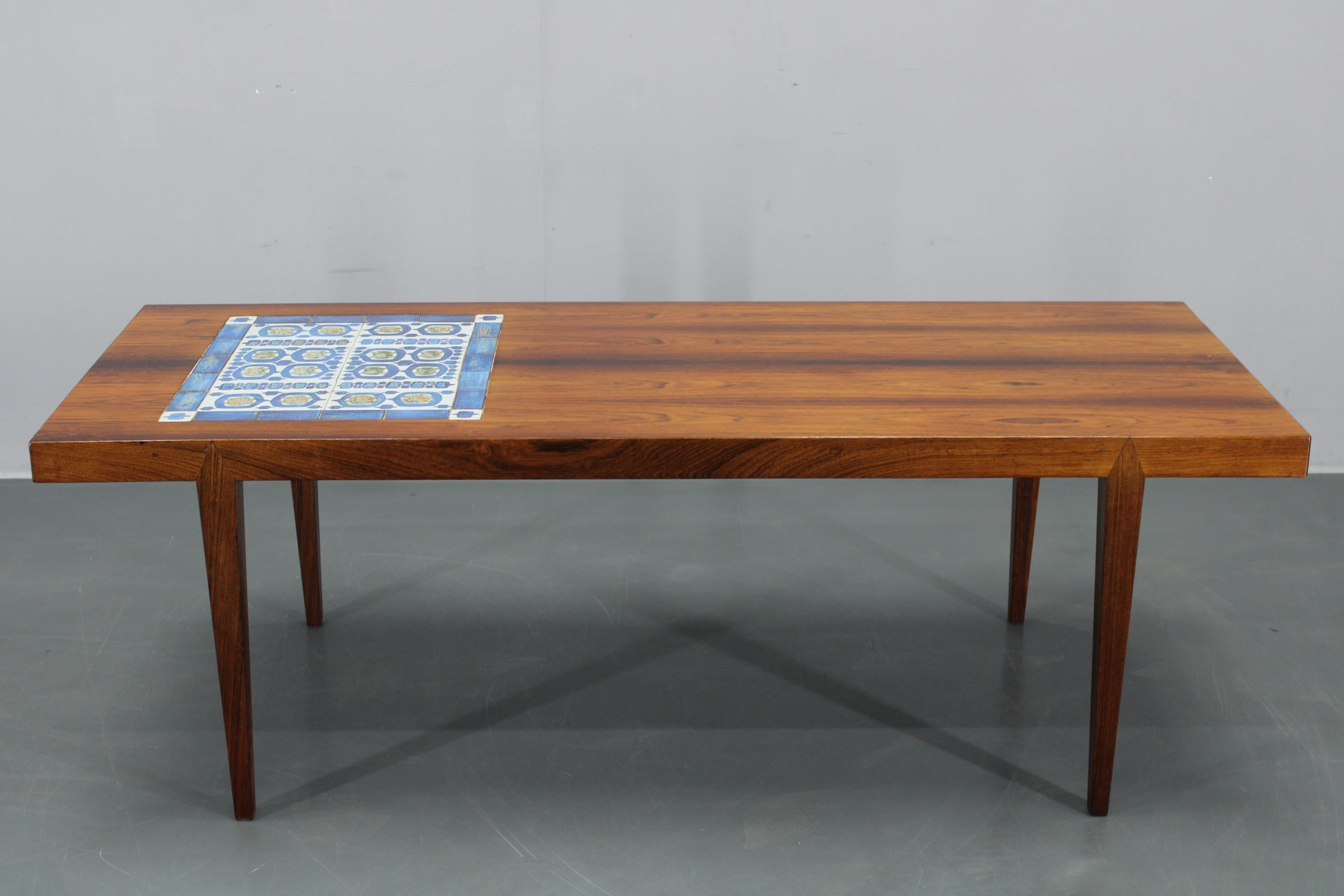 Vintage Danish mid-century coffee table designed and produced by Haslev Mobelsnedkeri in Denmark, circa 1960s. Crafted with high-quality wood veneer and a unique ceramic tile inlay, this piece showcases authentic Danish craftsmanship and elegant,