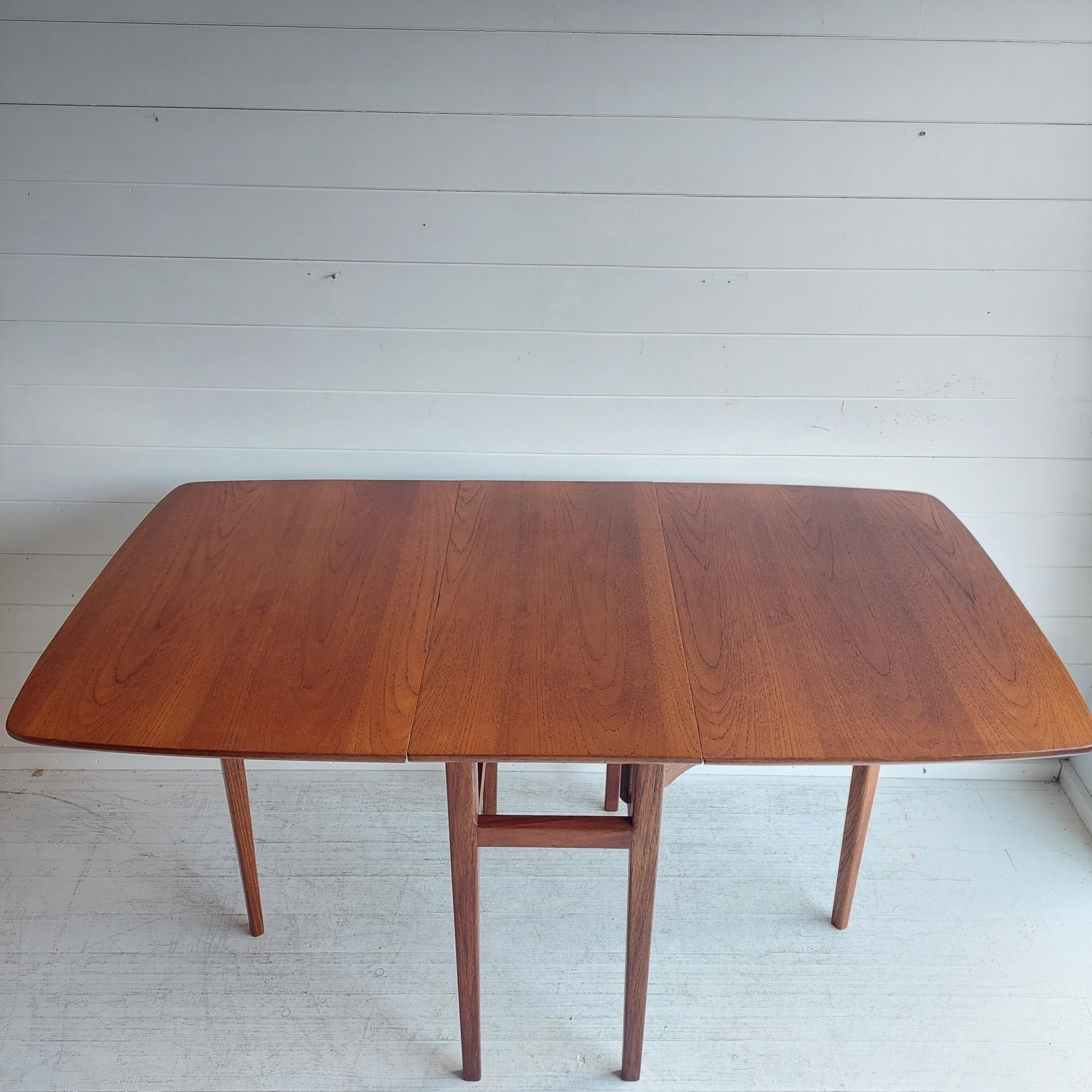 Mid Century Danish influenced Teak extendable dining table from the 70s

Fantastic teak dining table with extending leaves at each end.
A very sleek and practical design, the leaves can be placed up by using the legs to hold it in place to create a