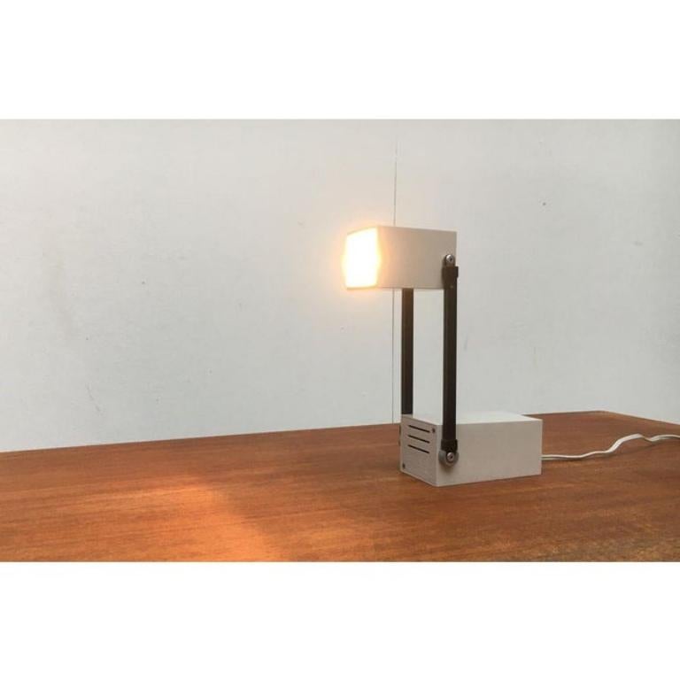 Rare table lamp by Louis Poulsen, designed by Bent Gantzel-Boysen from the 60s. A rare collector's item.

A compact travel light, which can be folded completely. The inconspicuous square reached unfolded a considerable size and becomes a full desk