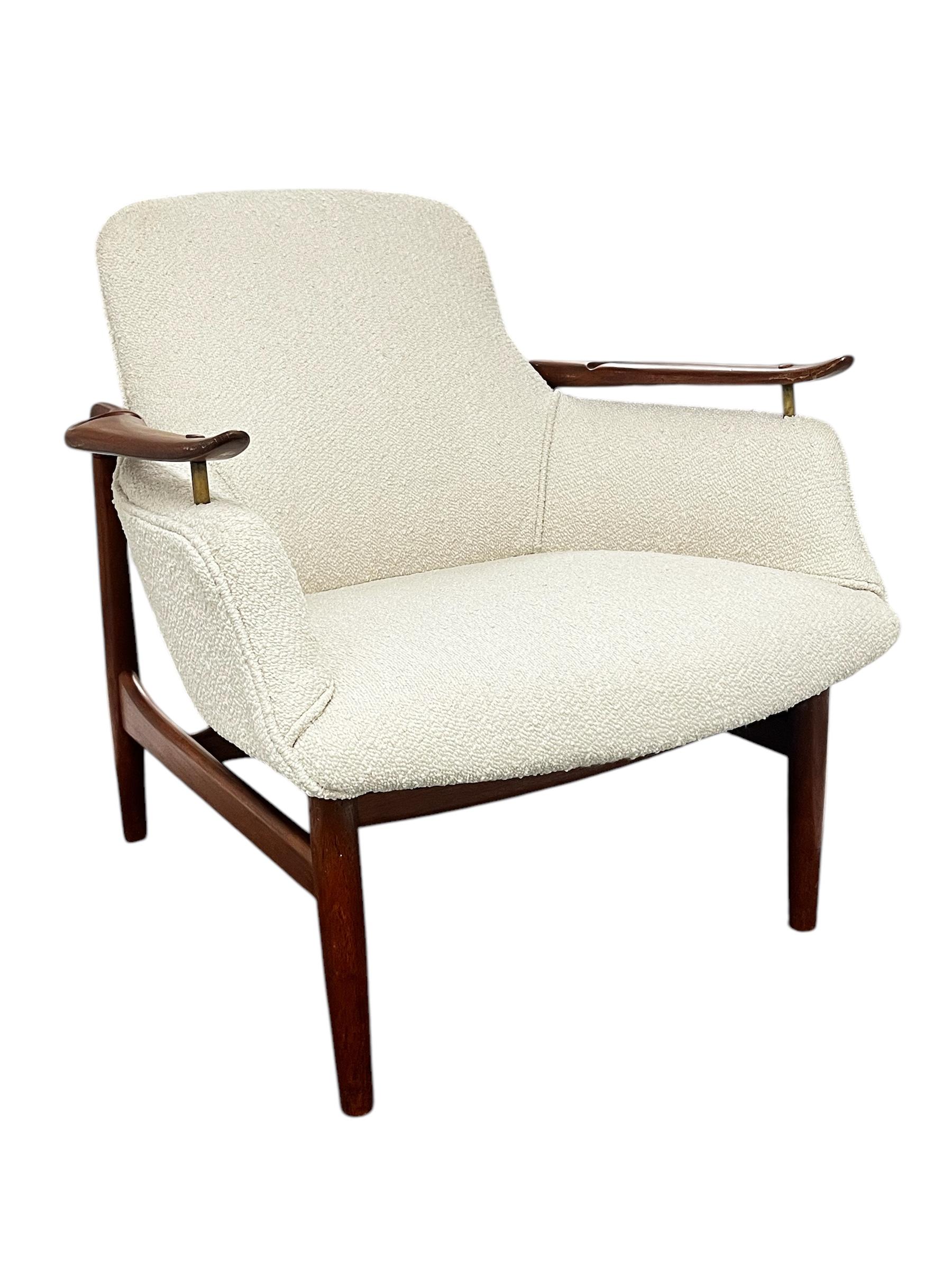 A vintage Mid-Century Danish Teak Lounge Chair in the manner of the Finn Juhl NV-53 Chair for Niels Vodder 1950's.  Chair has been professionally restored and reupholstered. There is no makers mark on chair but it is from an estate with mostly