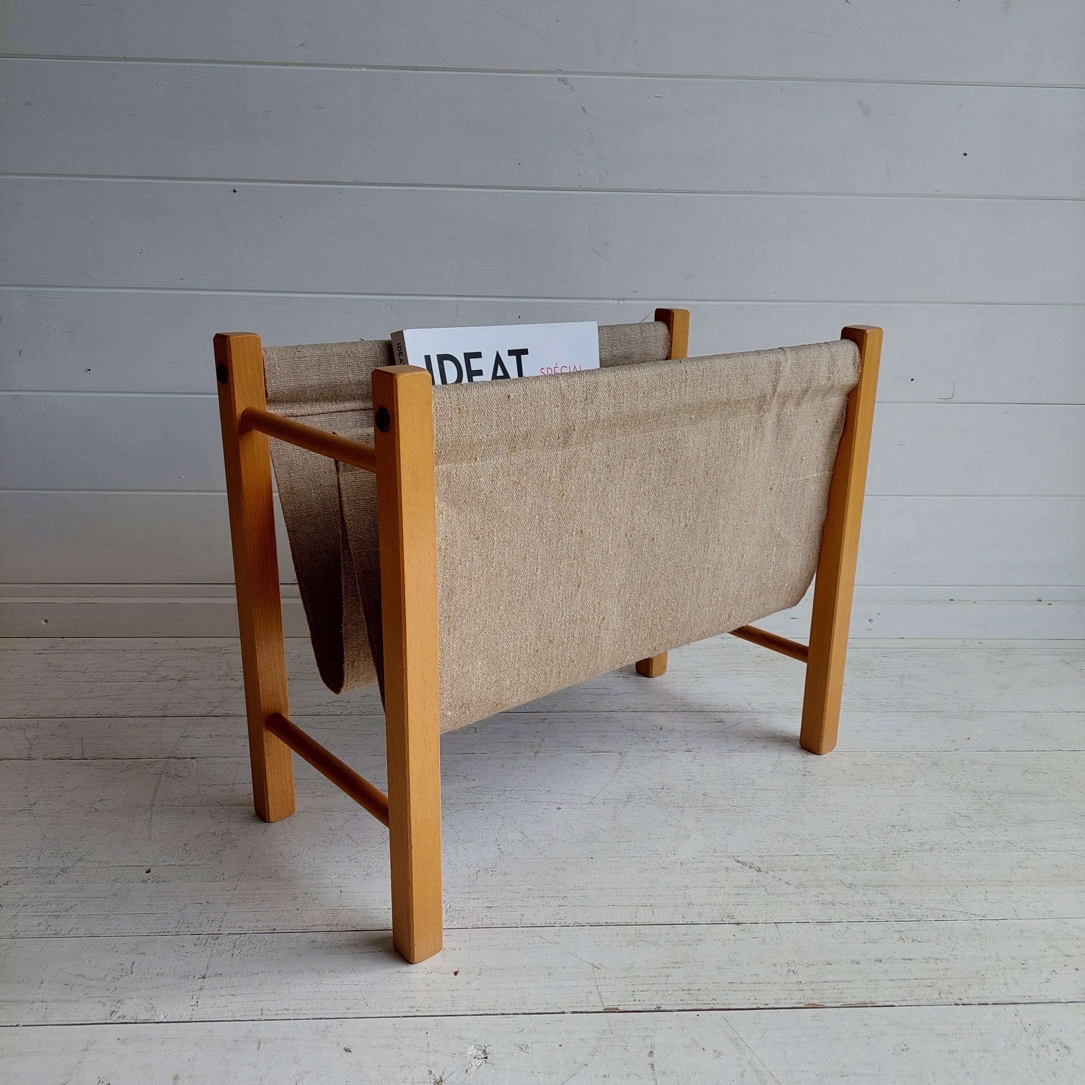 Magazine/Newspaper rack made from teak and natural linen. 
It was manufactured in Denmark during the 1960s 
Slim Mid-Century Modern PBJ Mobler Danish teak wood and linen magazine holder. 
A classic mid century, 2 bin, teak, magazine holder.
Sturdy