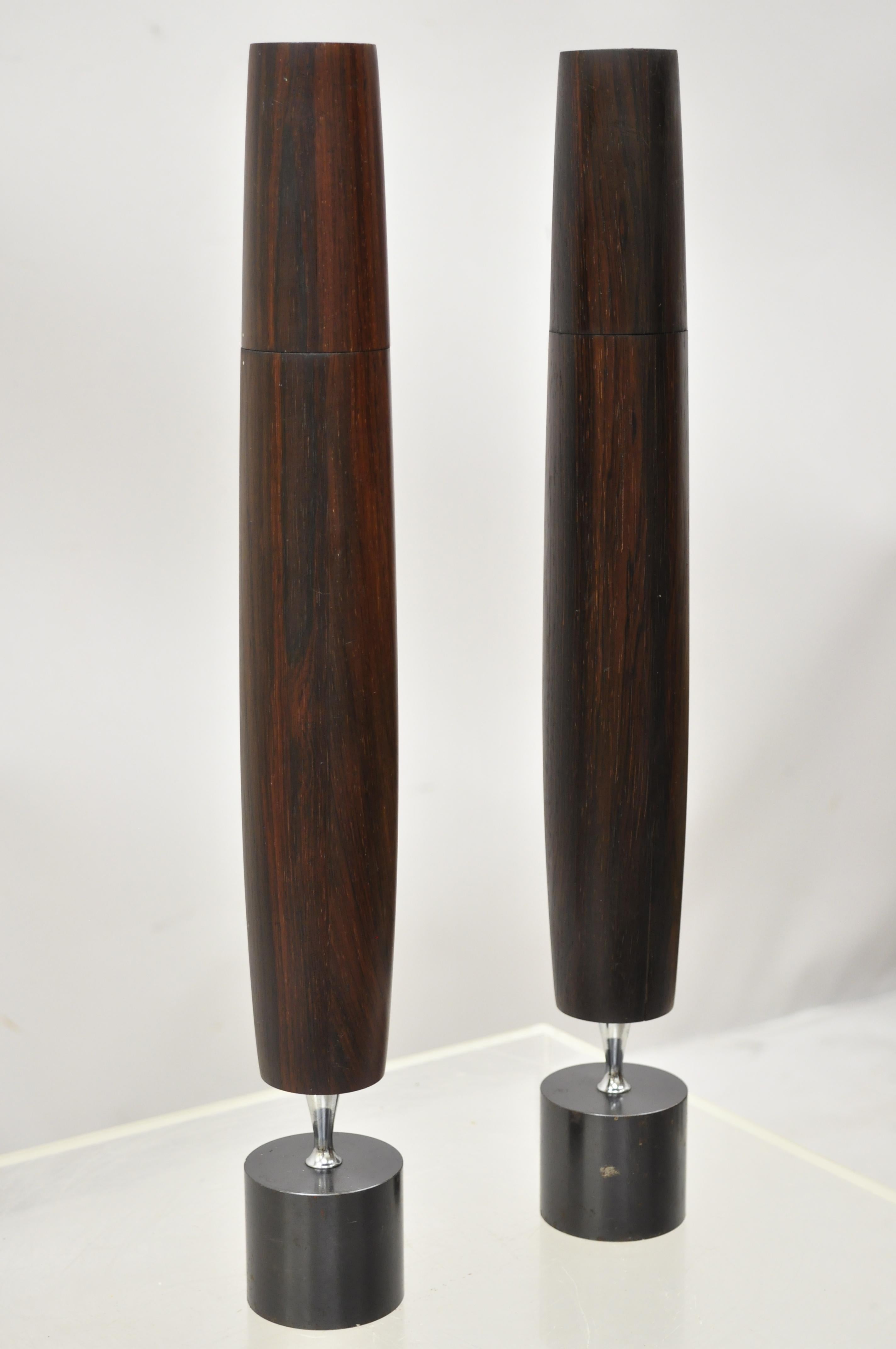 Mid Century Danish Modern 1964 Ronson Varaflame Rosewood Candlesticks - a Pair. Item features a heavy weighted iron base, butane lighter fluid, tall impressive form, solid wood construction, beautiful wood grain, original label, very nice vintage