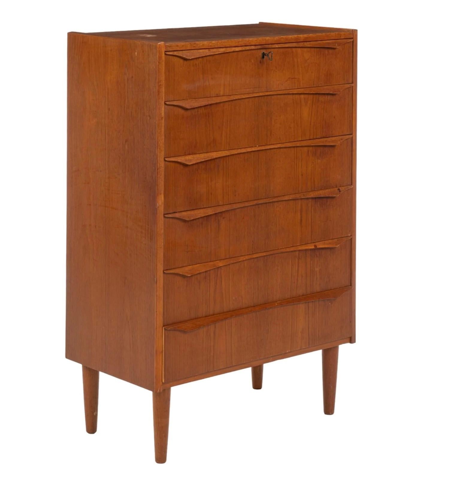 Danish Mid Century Teak Dresser with six drawers with wood pulls, with top drawer featuring key lock, supported on tapered legs, includes (1) key
 
 Measures height 43 in. x width 28 in. x depth 16 in.