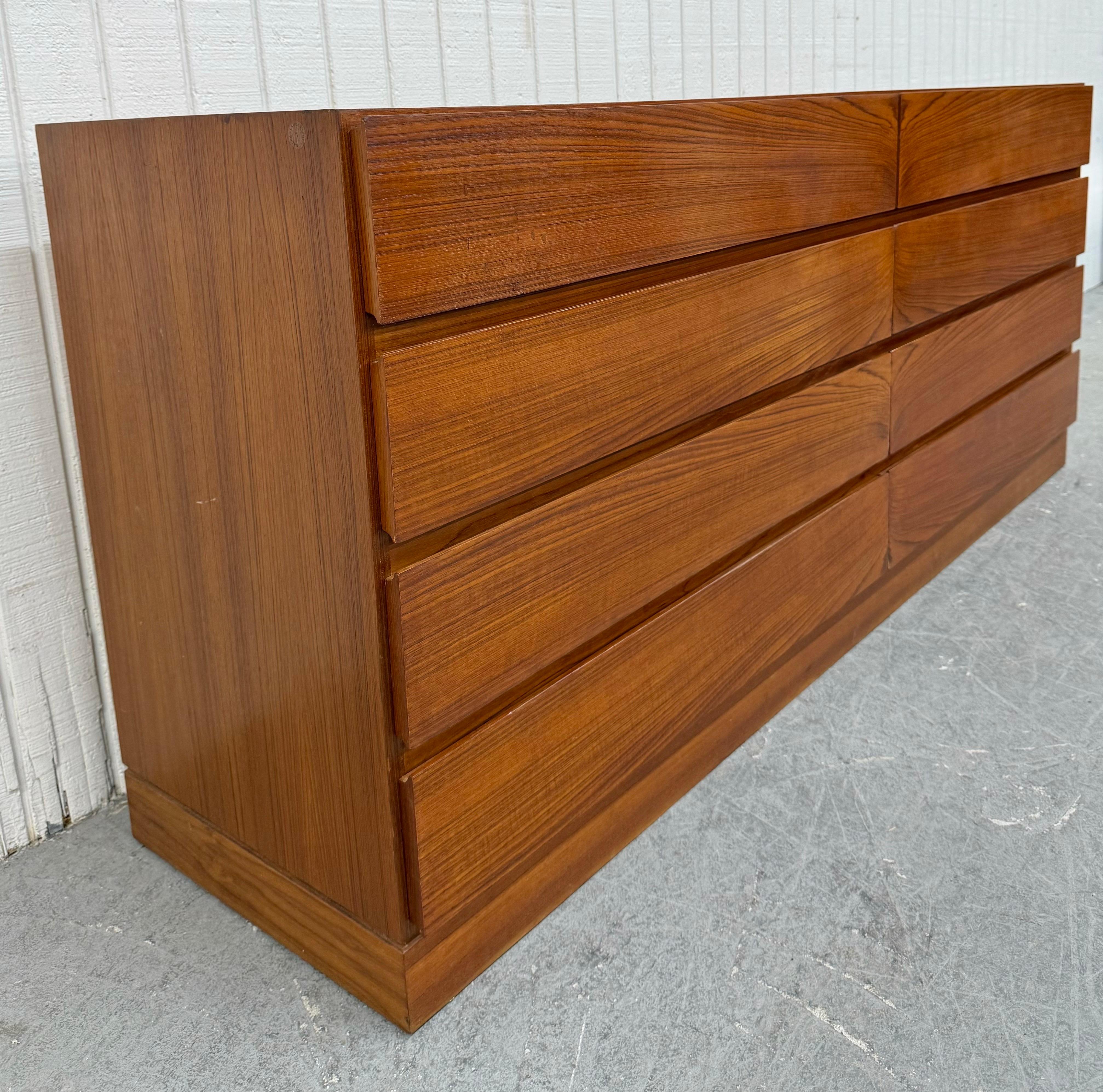 This listing is for a Mid-Century Danish Modern 8-Drawer Teak Dresser. Featuring a straight line design, eight drawers for storage, plinth base, and a beautiful teak finish. This is an exceptional combination of quality and design!