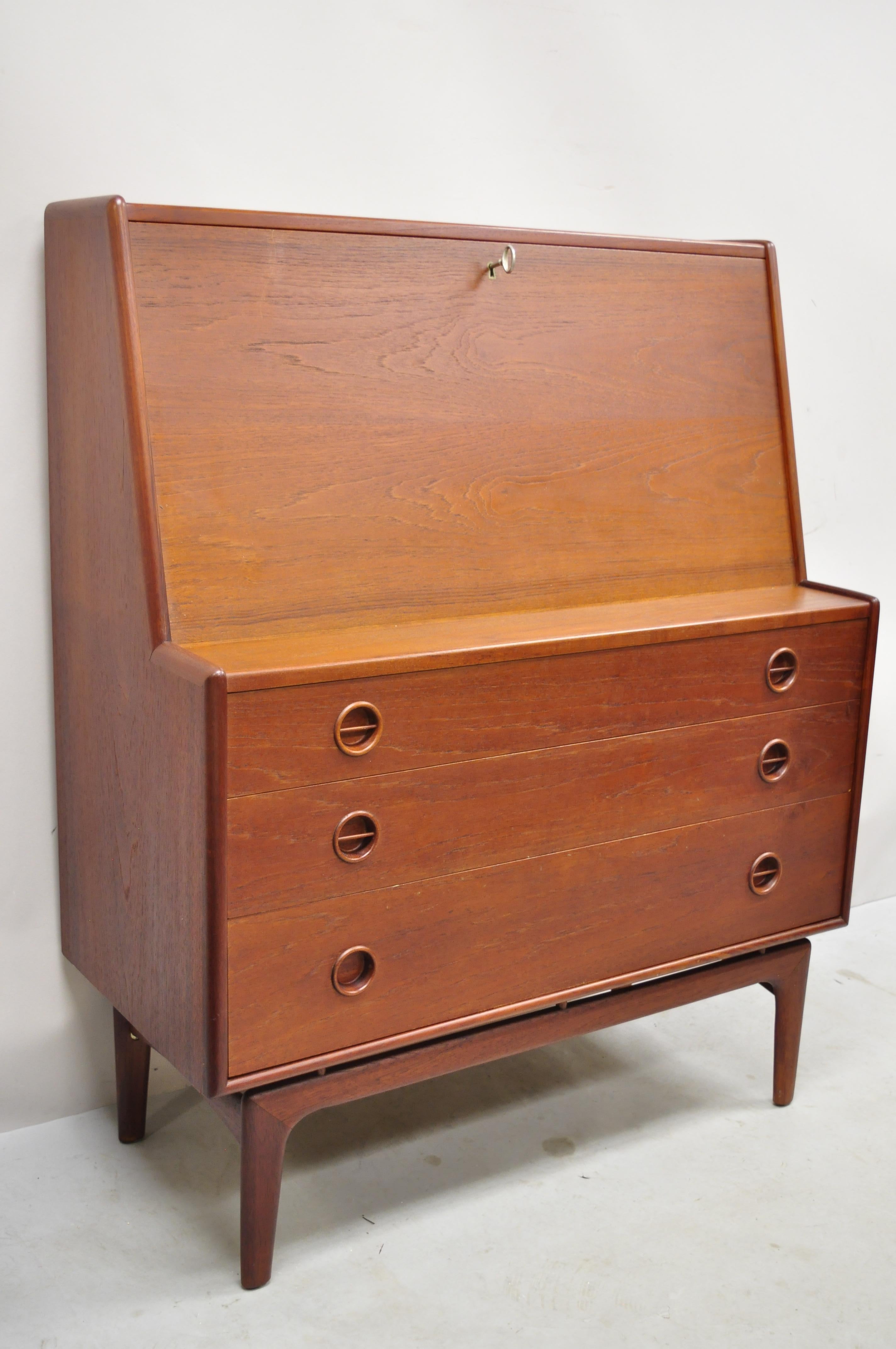 Mid Century Danish Modern Arne Hovmand Olsen MK Teak Drop Front Secretary Desk. Item features sculpted wood floating base, drop front lid with fitted interior, beautiful wood grain, original label, working lock and key, 3 dovetailed drawers, very