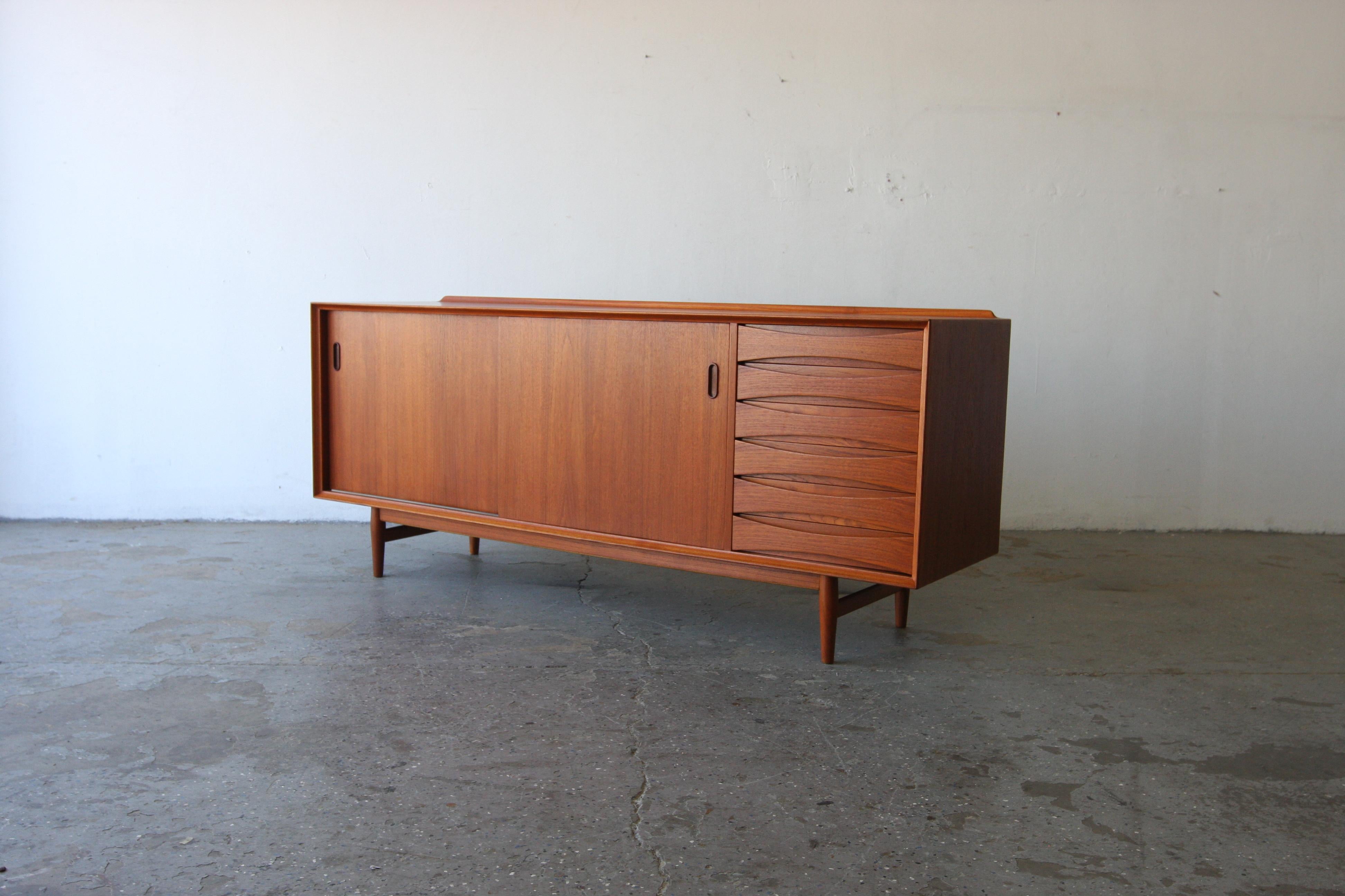 Danish teak credenza designed by Arne Vodder for Sibast. Timeless and functional design has 6 drawers and two sliding doors. Fully refinished teak on all sides, allowing the piece to be admired from any angle and get the attentions it deserves.

