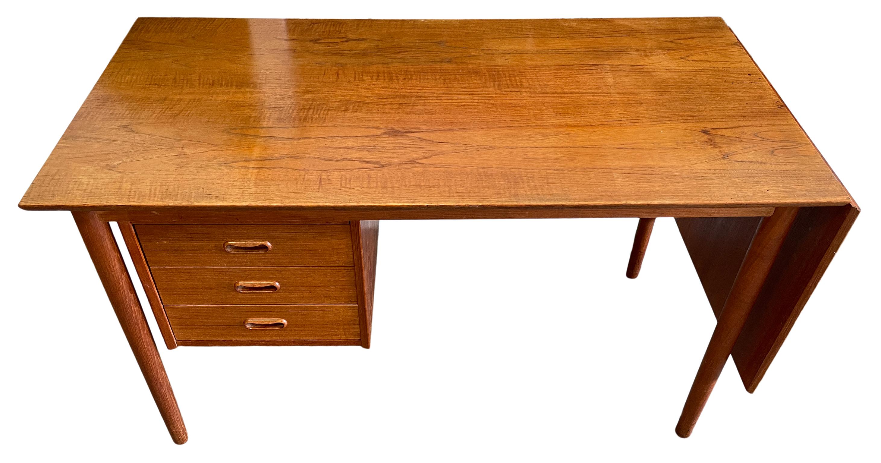 Mid century Danish modern Arne Vodder teak drop leaf desk for H.Sigh Denmark. 
Beautiful Teak desk with 3 drawer and 1 removable extension leaf on the right side. Desk top slides left to be fully extended. The set of 3 drawers slides from left to