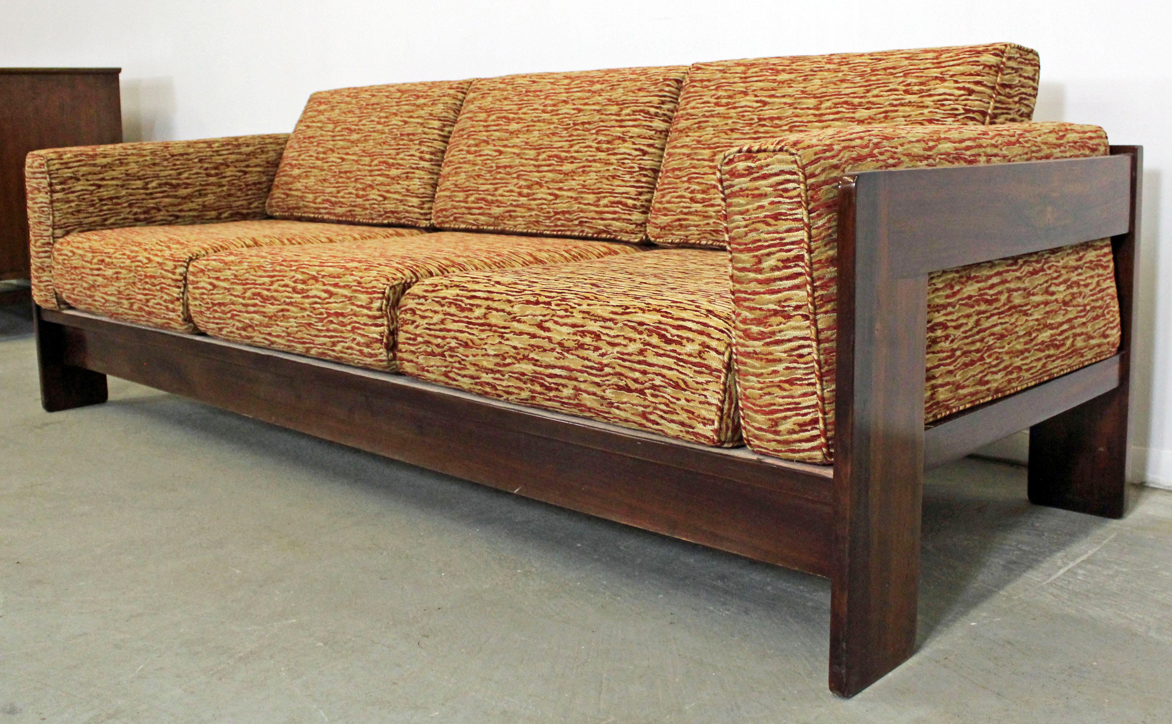 What a find. Offered is a Mid-Century Modern rosewood three-seat sofa. This is the 