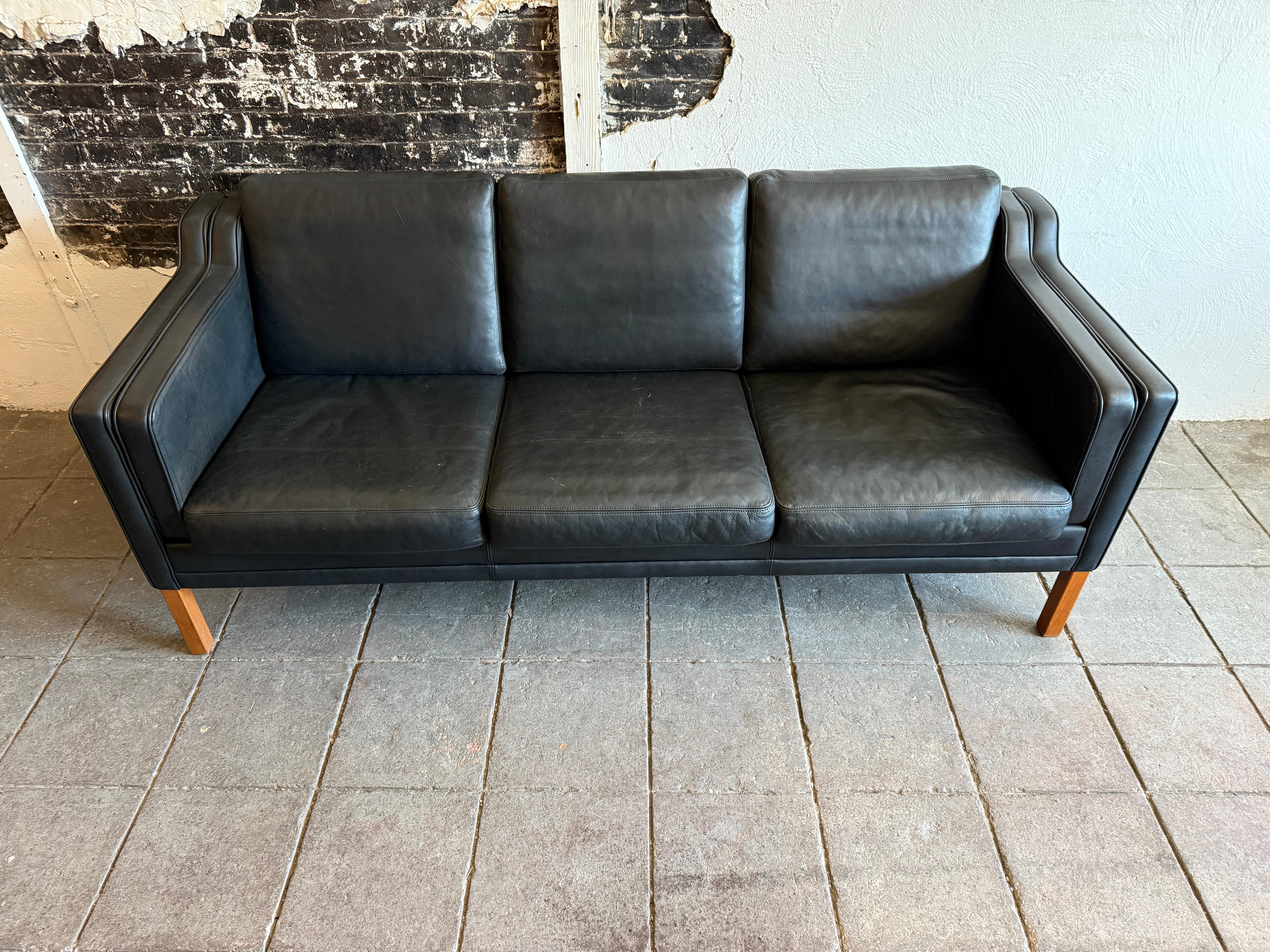 Very clean mid century Danish modern Black leather 3 seat sofa with birch legs. Style of Børge Mogensen. Beautiful Black leather is soft and shows little to no signs of use but broken in nicely. Minor fading from use. Great Danish Modern sofa.