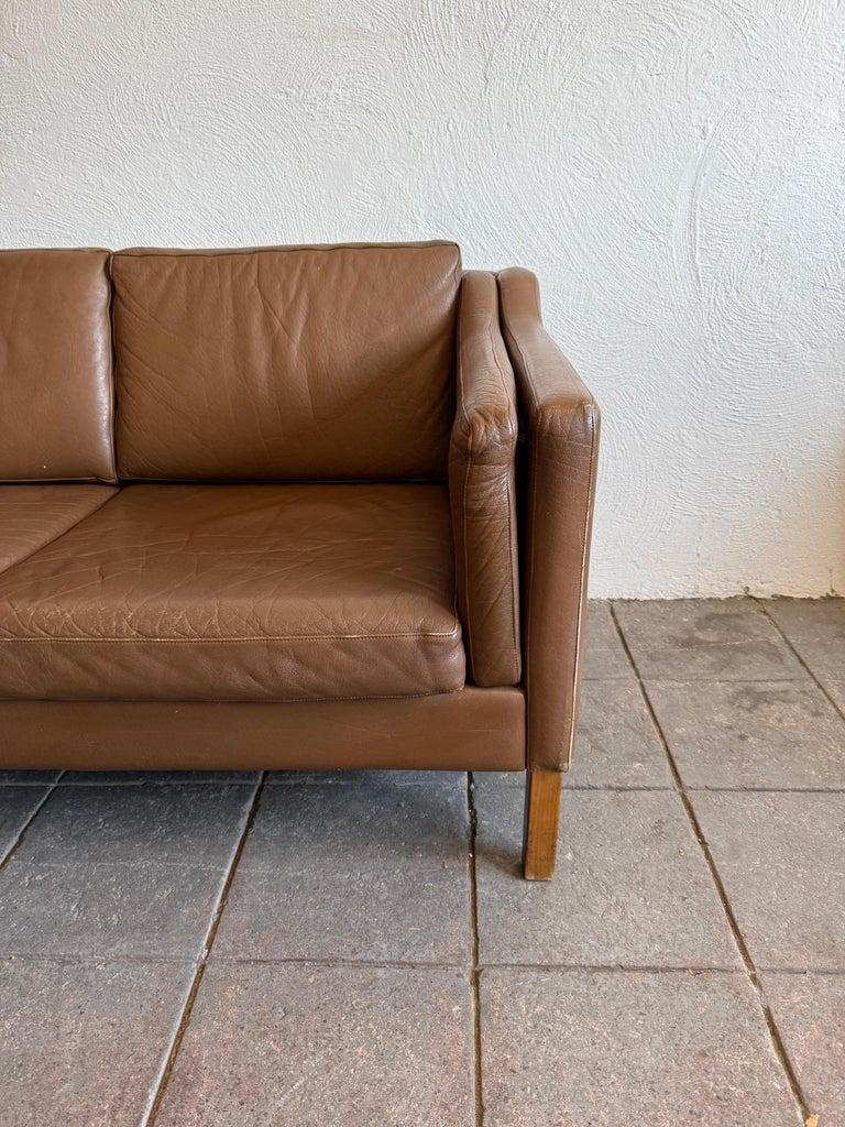 Mid century Danish modern beautiful brown leather 3 seat sofa wood legs. Style of Børge Mogensen.  Medium Brown leather is soft and shows little signs of use but broken in nicely. Great Danish Modern sofa. Great condition. Sofa is made l in Denmark.
