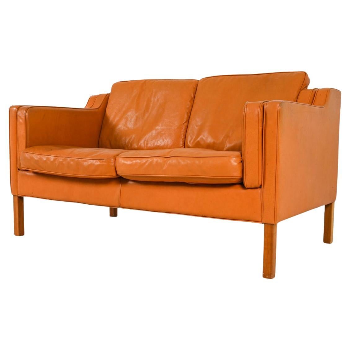 Midcentury Danish modern beautiful butterscotch leather 2 seat sofa birch legs. Style of Børge Mogensen. Beautiful butterscotch leather is buttery soft and shows little to no signs of use but broken in nicely. Cushions have original down filled