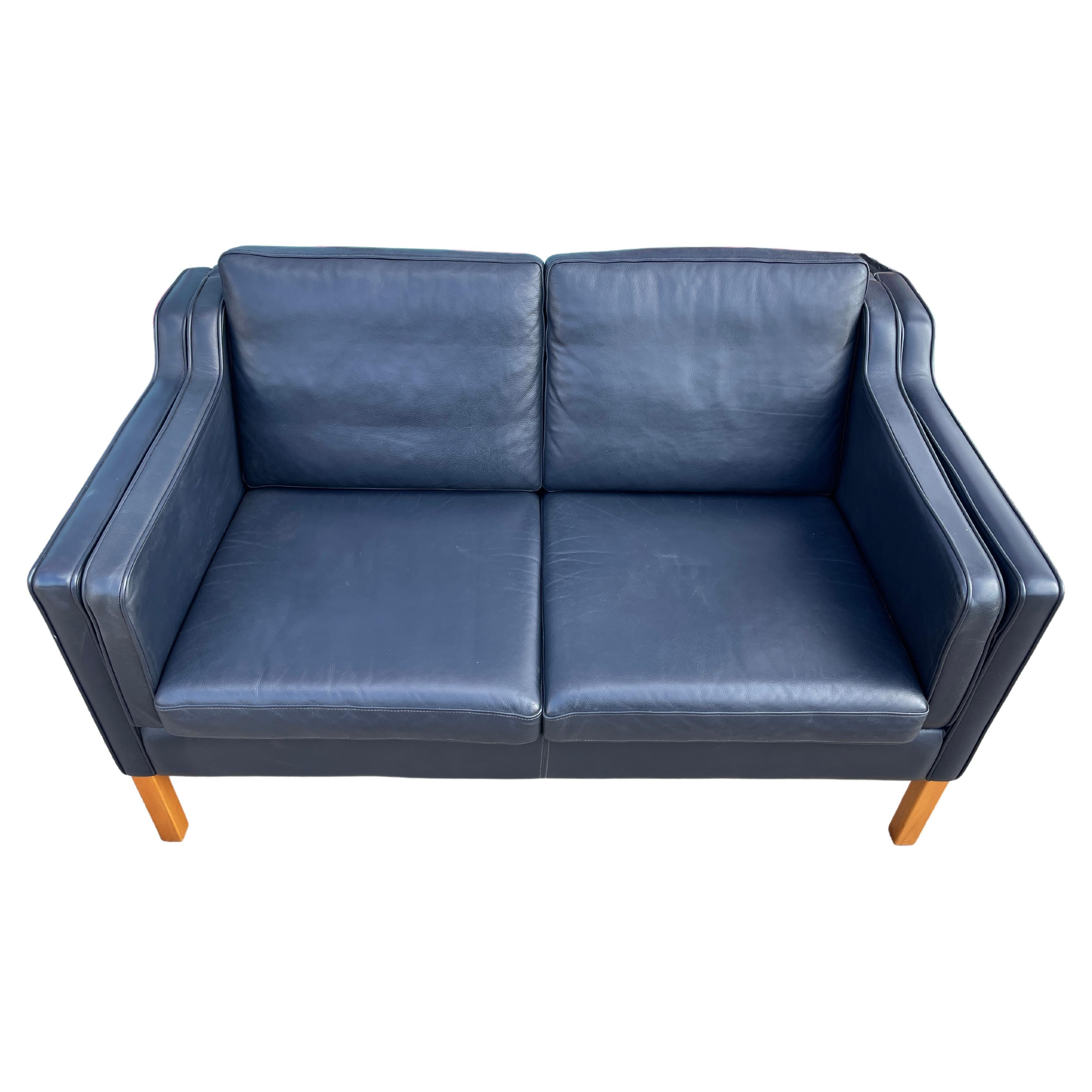 Mid century Danish modern beautiful Dark Navy Blue leather 2 seat sofa birch legs. Style of Børge Mogensen. Beautiful Navy Blue leather is soft and shows little to no signs of use but broken in nicely. Great small Danish Modern sofa. Great
