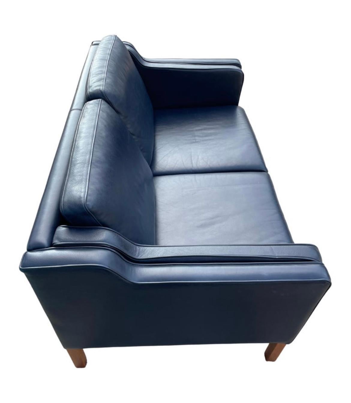 Midcentury Danish modern beautiful dark navy blue leather 2 seat sofa birch legs. Style of Børge Mogensen. Beautiful Navy Blue leather is soft and shows little to no signs of use but broken in nicely. Great small Danish Modern sofa. Great condition.