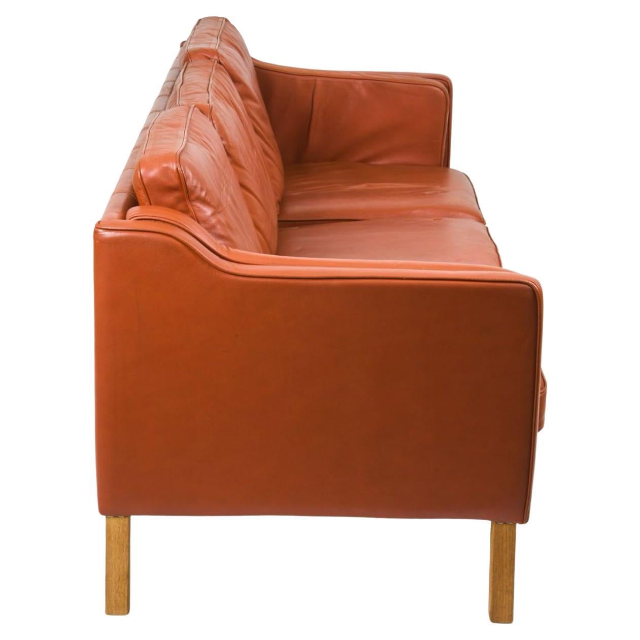 Mid century Danish modern Red leather 3 seat sofa Birch wood legs. In the style of Børge Mogensen. Beautiful Red leather that shows little Patina/wear soft and broken in nicely. Has all original Down filled cushions. Great Danish Modern sofa in worn