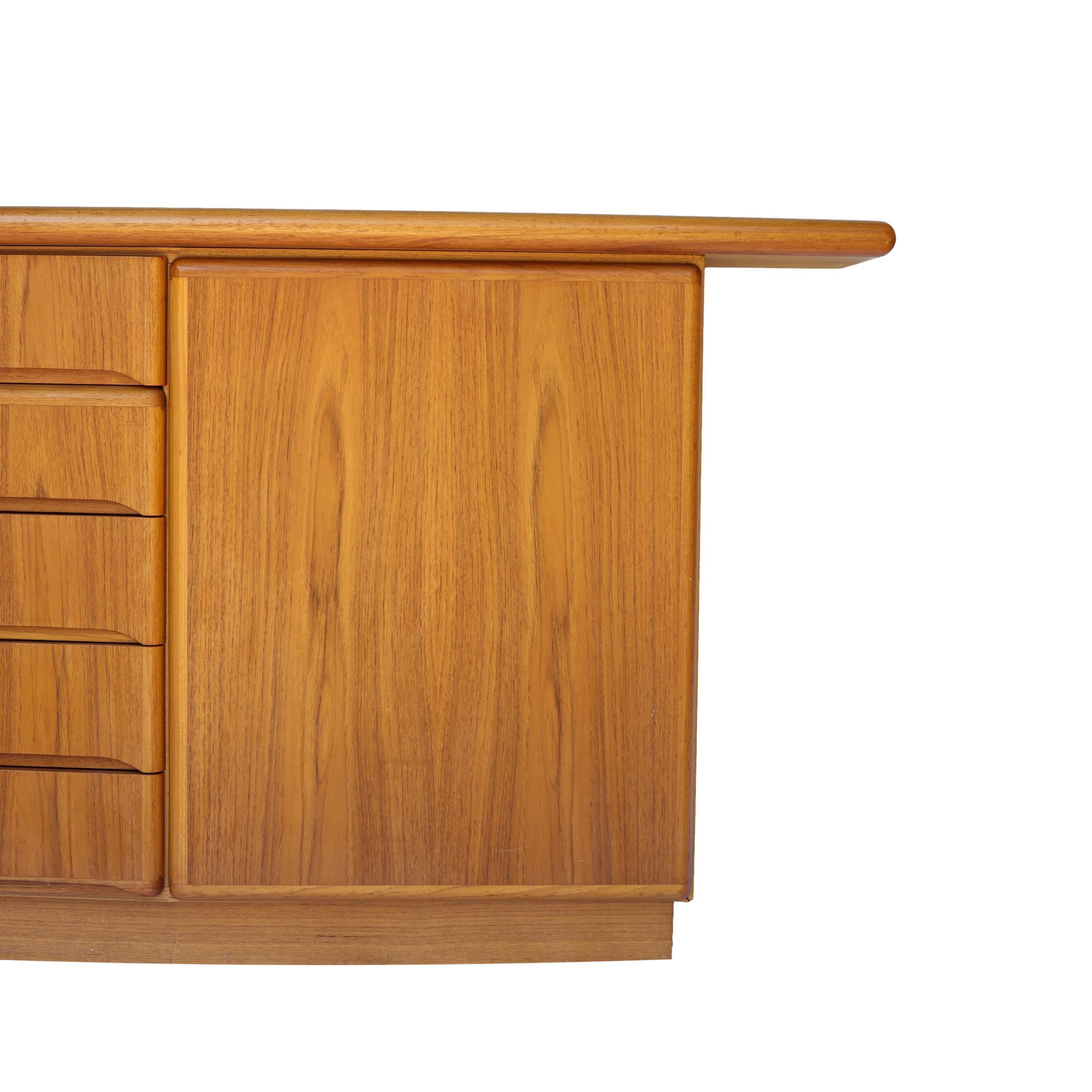 Mid-Century Danish Modern Bowfront Rosewood Sideboard by Slovby Mobelfabrik, Denmark, Model Number RS26B, ca. 1968. The slightly bow-fronted case with five central drawers, and cabinet doors with interior shelving on either side. 
Recently polished