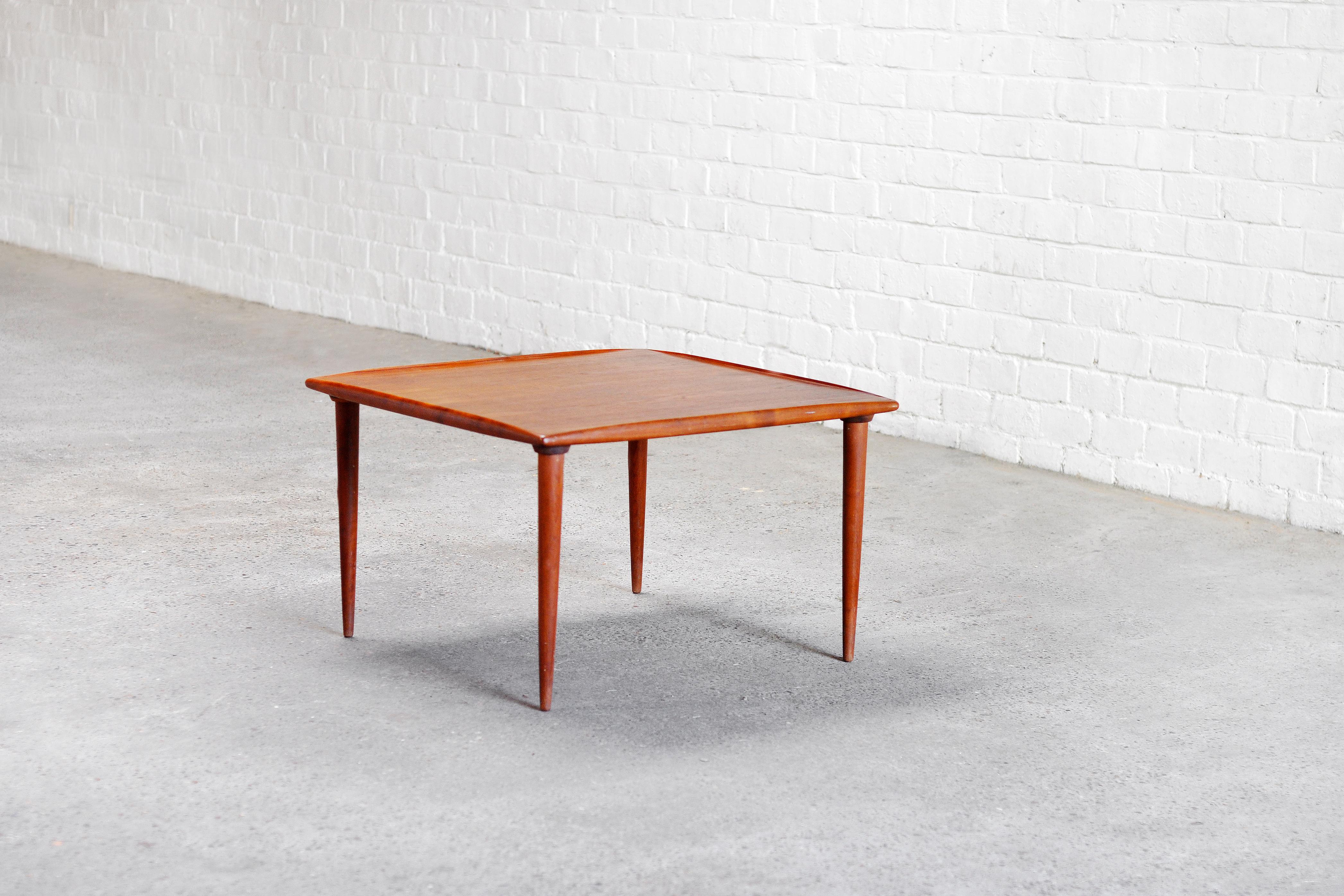 Mid century Danish modern coffee table attributed to Finh Juhl. This beautiful piece features a teak top with a curled lip edge on tapered legs. A great addition to any modern living or workspace. Wear consistent with age and use.