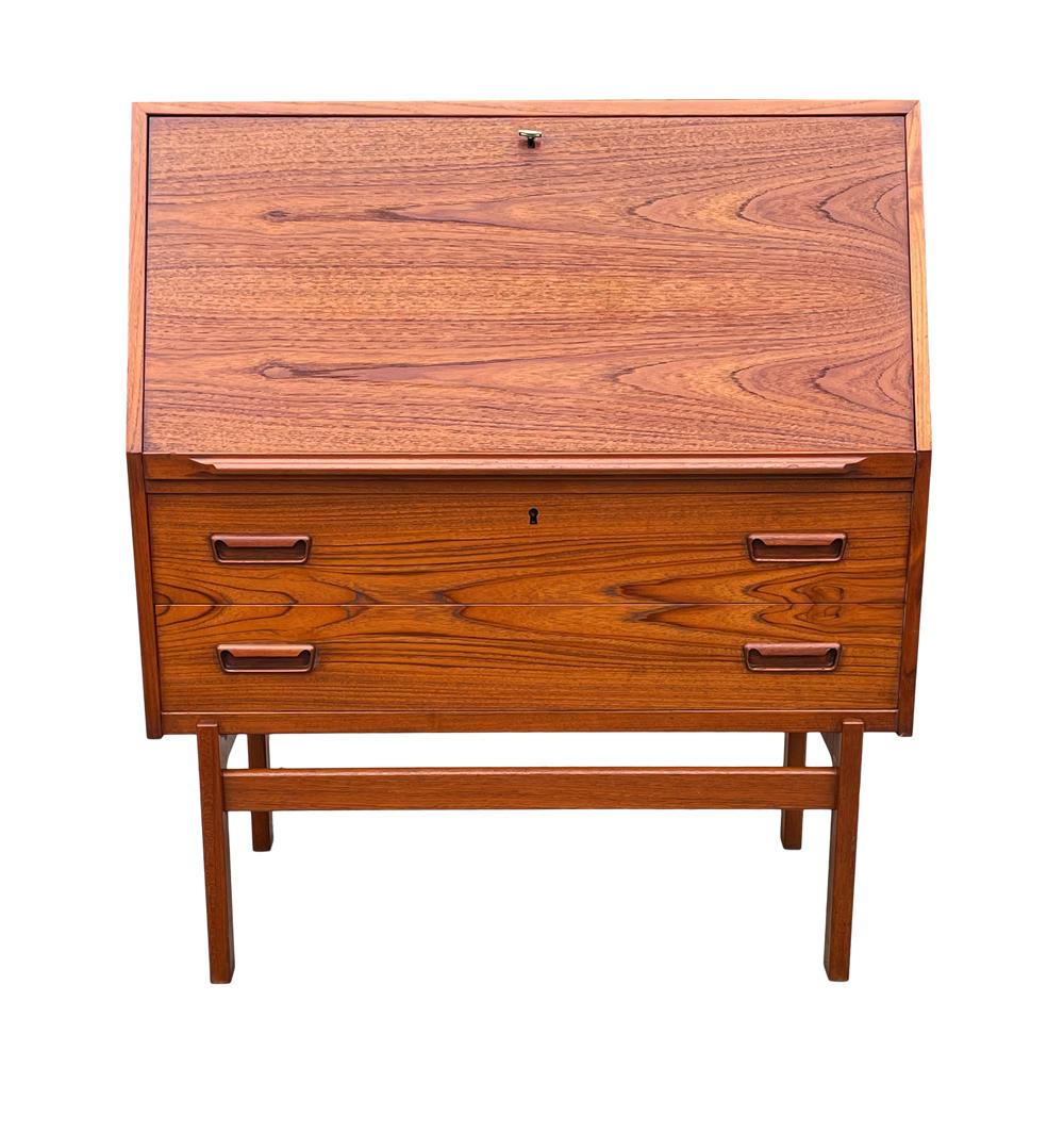 A sleek modern desk from Denmark, circa 1960s. It features all teak wood construction with drop Front Design. Very good vintage condition.