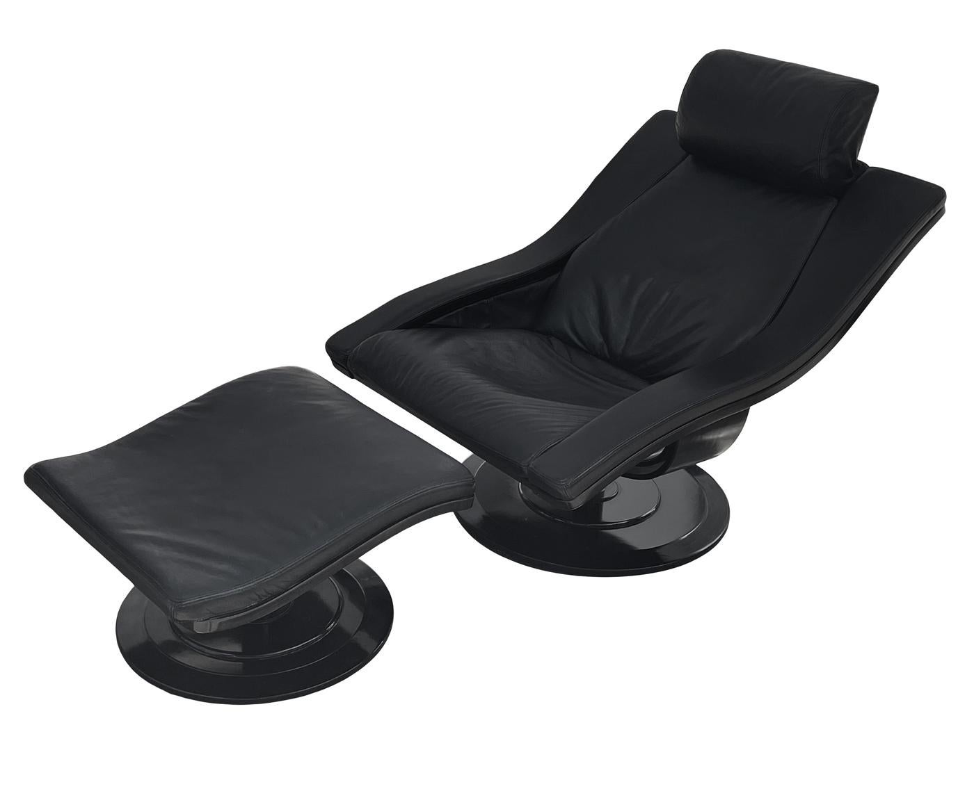 Nelo Sweden swivel lounge chair by Takashi Okamura & Erik Marquardsen, in black leather with matching ottoman. Heavy well-made set with black ebony wood bases. Price includes the set. Ottoman measures 21