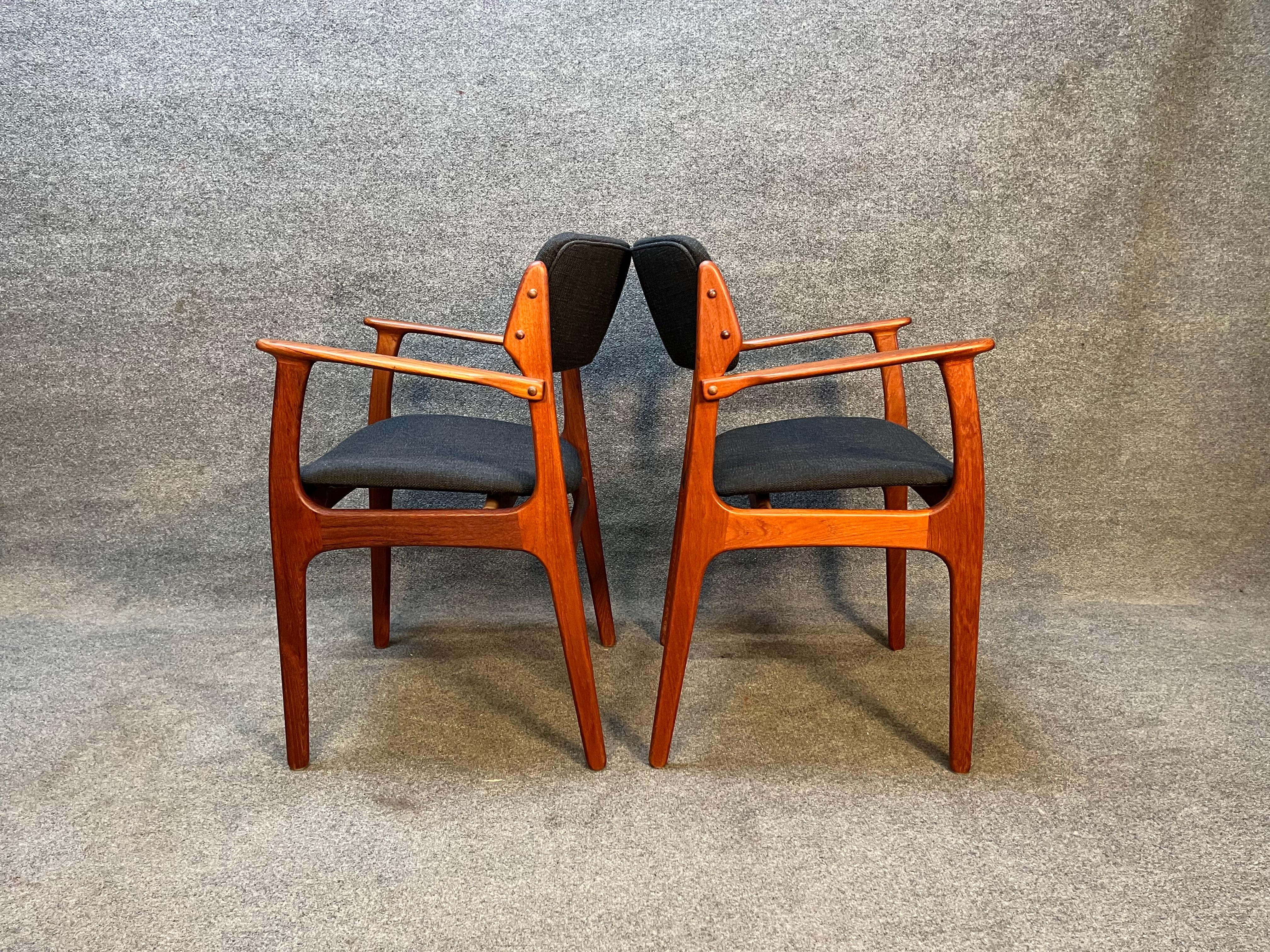 Here's is an amazing pair of the quintessential Danish teak dining chairs designed by Erik Buch Model 49. these chairs have been completed refinished and have brand new charcoal black fabric and foam. These are the captains chairs. If your'e looking