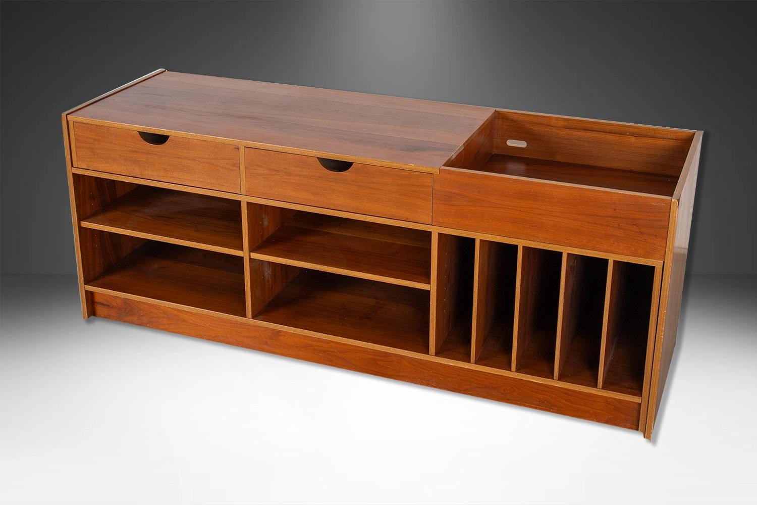 A teak media record cabinet with incredible form and presence. This attractive, original Danish Modern adjustable teak media display cabinet, made in Sweden circa 1960’s. Features two separate pieces allow for angled or varied length linear set up.