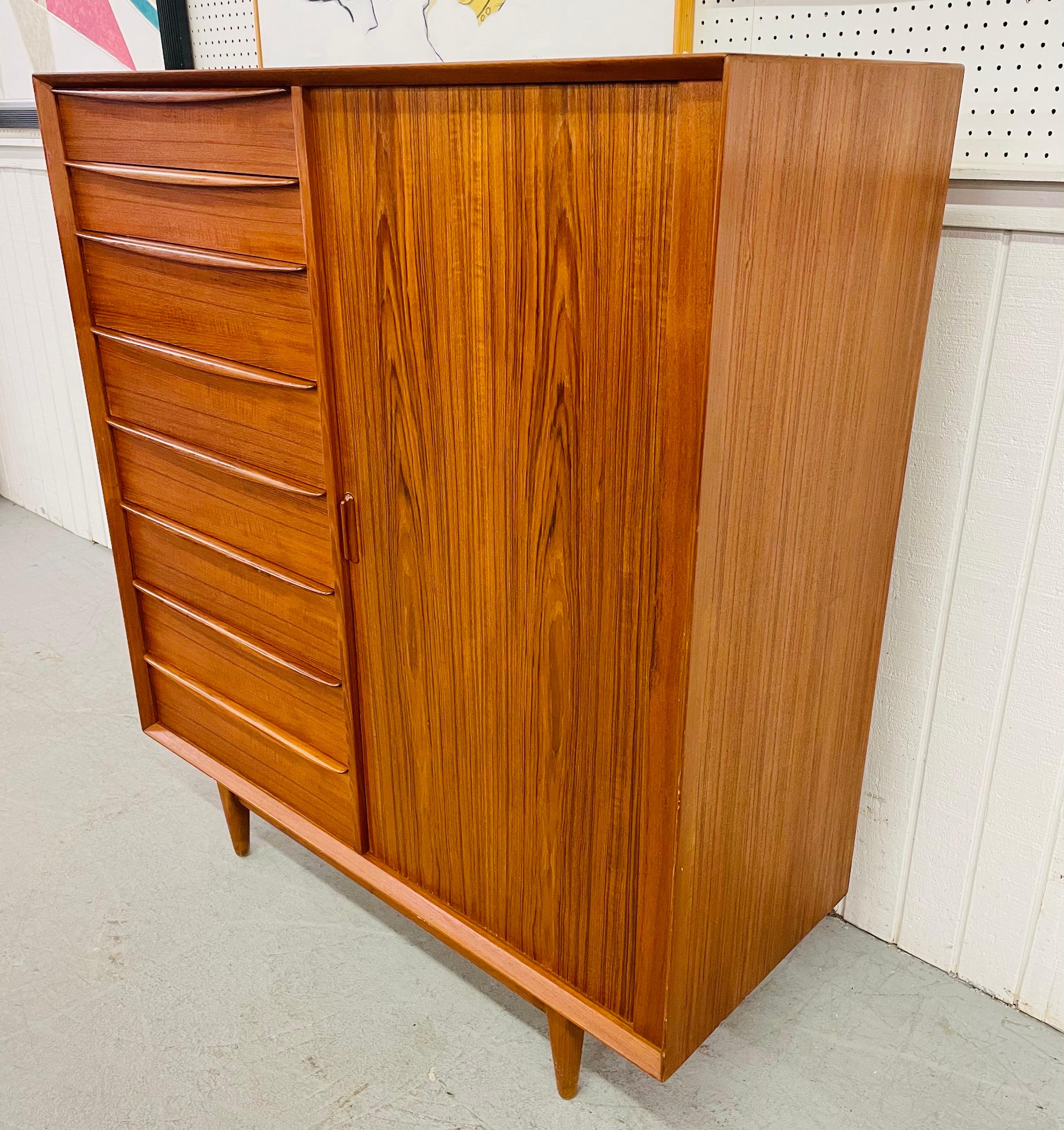 This listing is for an exceptional Mid-Century Danish Modern Falster Teak Tambour High Chest. Featuring eight drawers on the left, a tambour sliding door on the right that opens up to nine hidden drawers, and a beautiful teak finish.