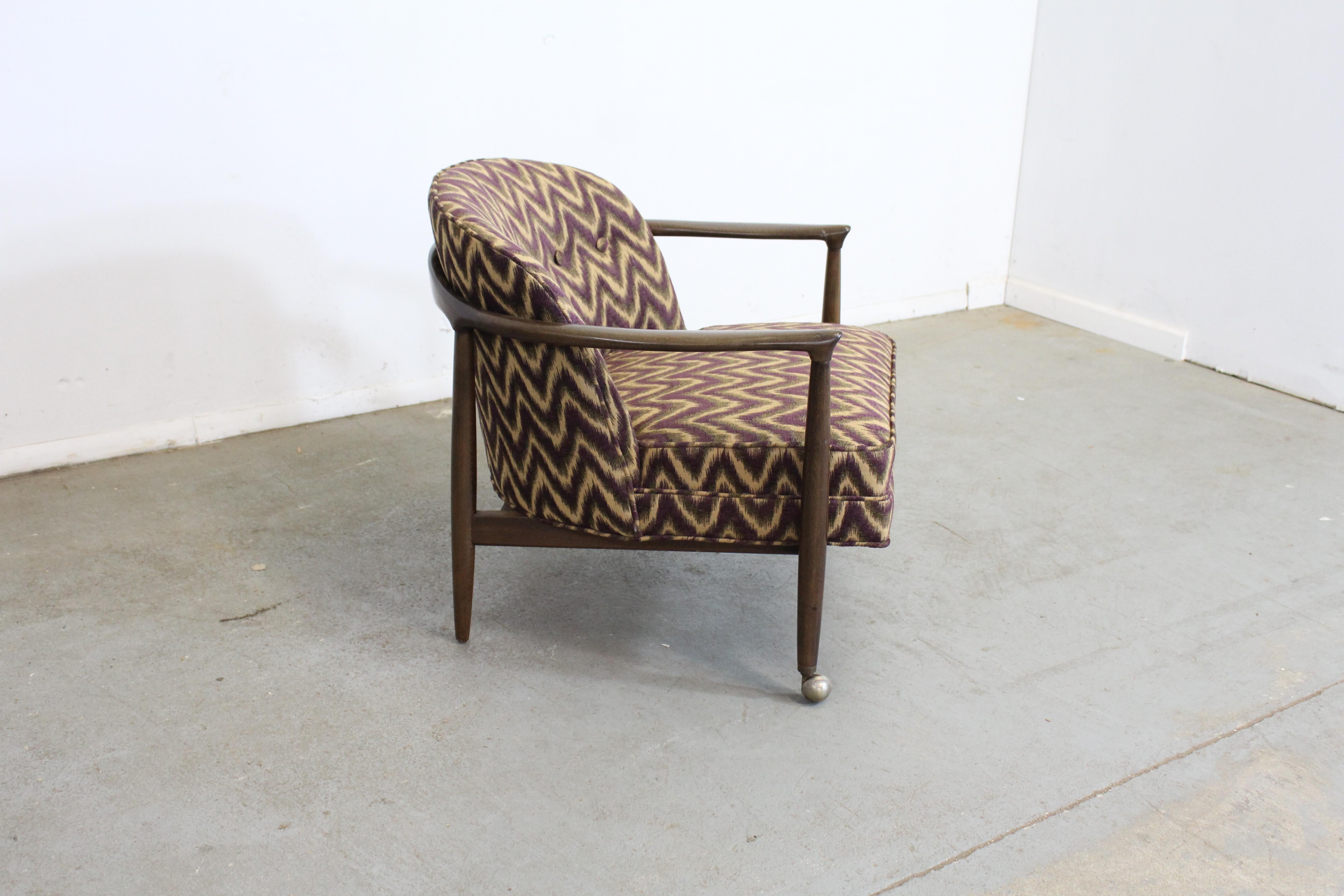 Mid-century Danish modern barrel back club chair

Offered is a vintage mid-century Danish modern chair by Finn Andersen for Selig. It is signed by Selig and made in Denmark. It features a geometric fabric in the color 