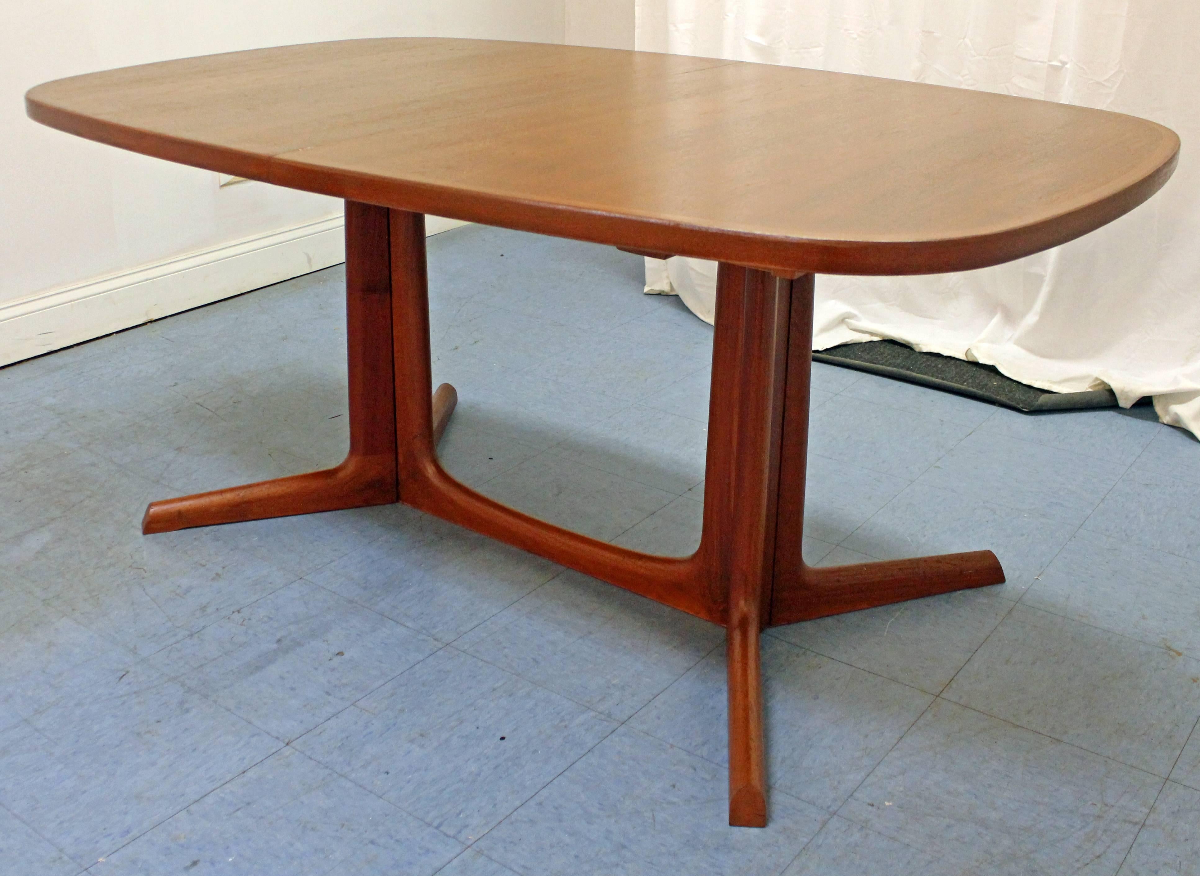 This table has been refinished. Includes two extension boards and is made of teak. Signed by Gudme.