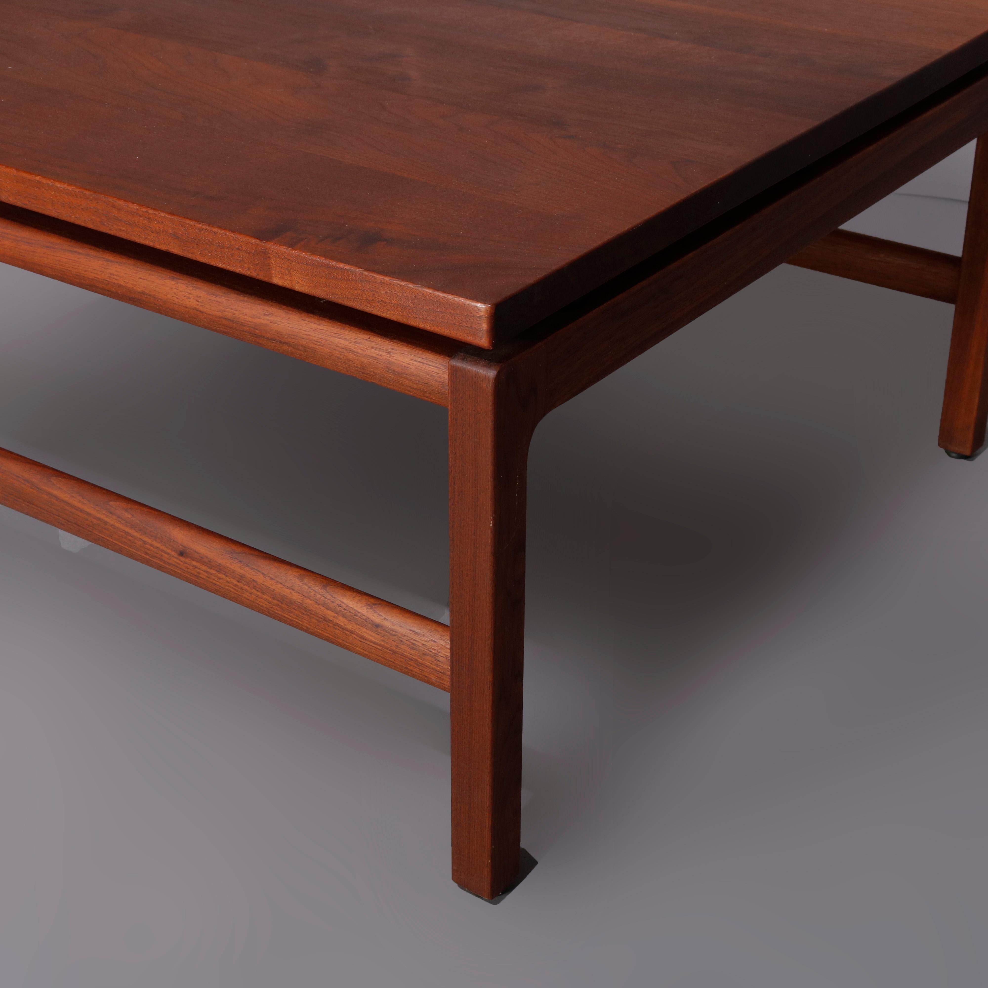 A midcentury Danish modern coffee table by Gunlocke offers walnut construction with elevated square top surmounting base having straight and squared legs with H-stretchers, Gunlocke New York, mid-20th century.

***DELIVERY NOTICE – Due to COVID-19