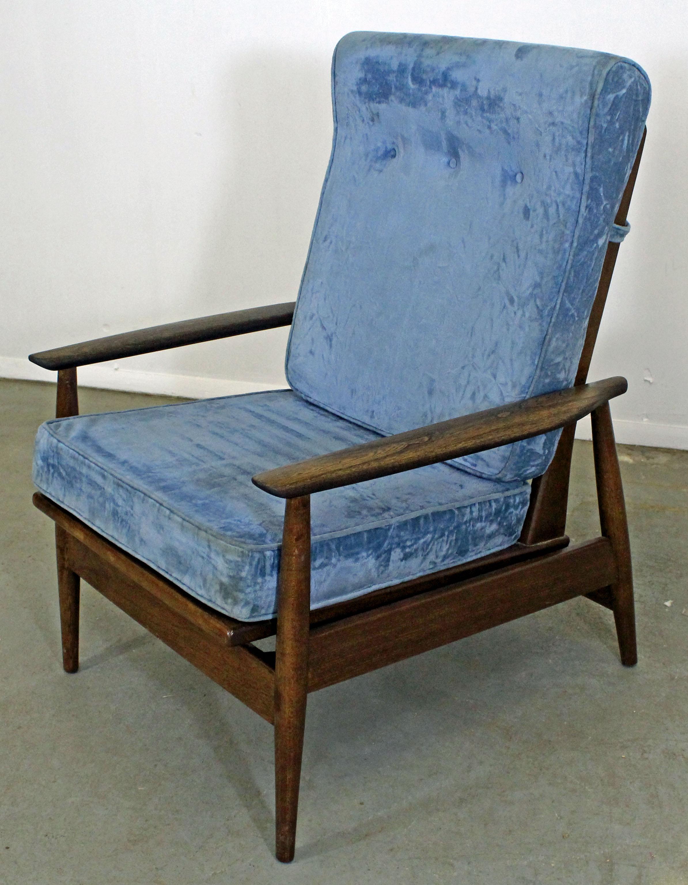 Offered is a Mid-Century Modern walnut lounge chair with a high-back and blue upholstered cushions. Has springs under the seat for rocking. It is in very good condition for its age (light stain on upholstery, minor surface scratches, wear--see