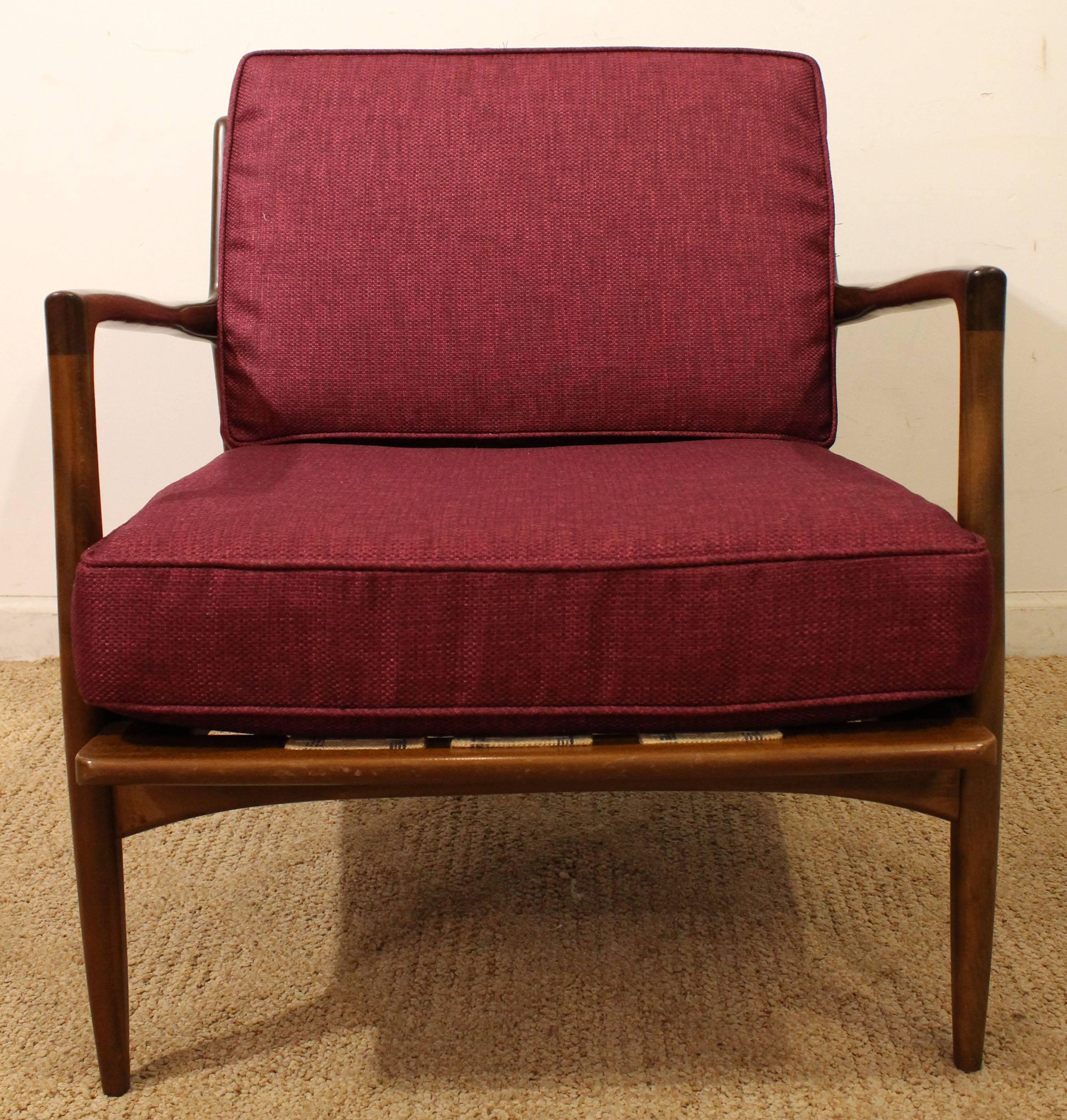 This piece is made of walnut and has been reupholstered with new fabric. We believe it is an earlier unsigned IB Kofod-Larsen for Selig lounge chair.