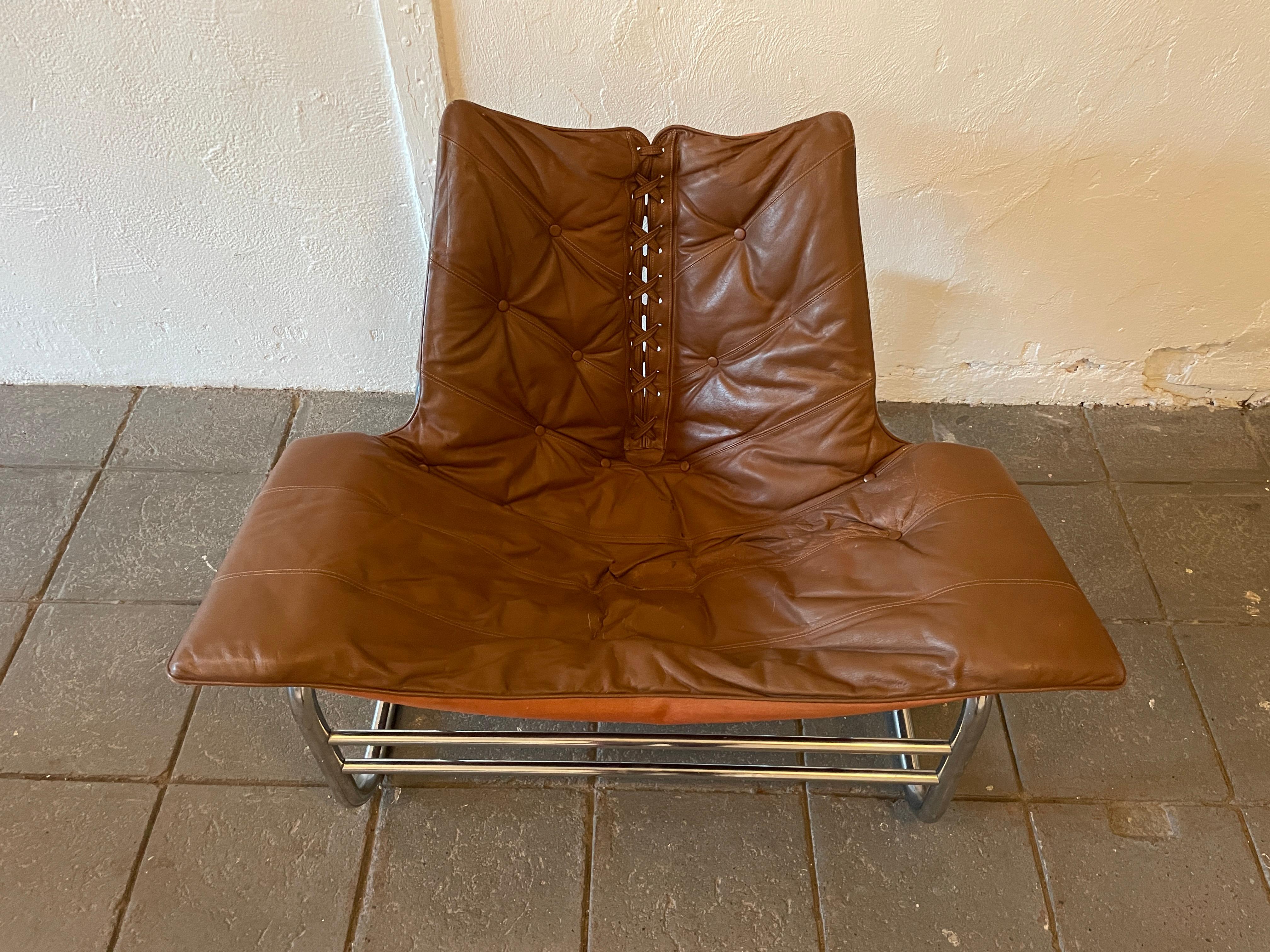 Mid Century Danish modern Johan Bertil Corset brown leather sling Lounge Chair. Leather is sofa and broken in chrome is in great condition. Swedish designer made in Denmark circa 1970 labeled. Ready for use. Beautiful designed chair. Located in
