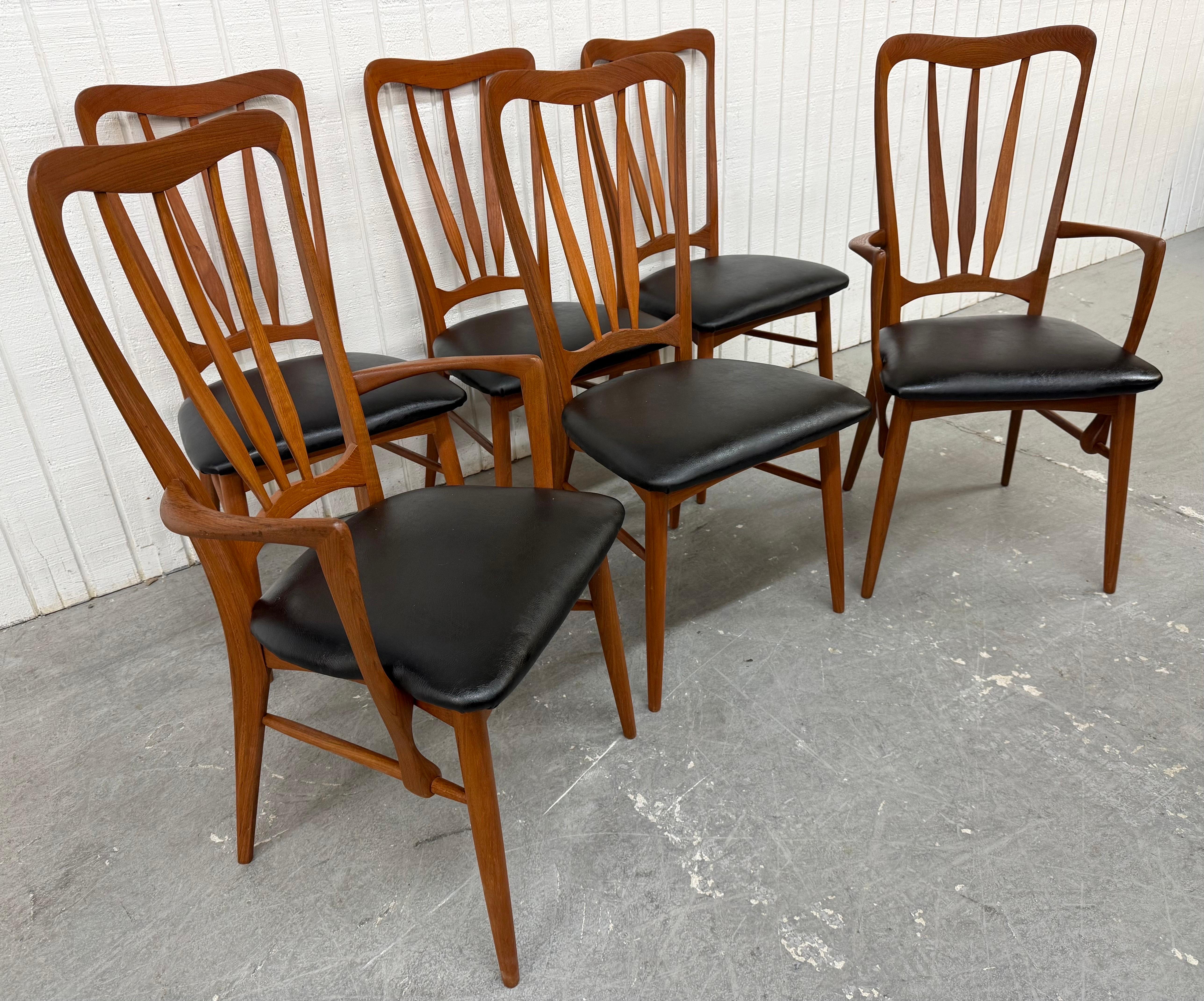 This listing is for a set of six Mid-Century Danish Modern Koefoed Ingrid Teak Dining Chairs. Featuring two arm chairs, four side chairs, newly upholstered black vinyl seats, and a beautiful teak finish. This is an exceptional combination of quality