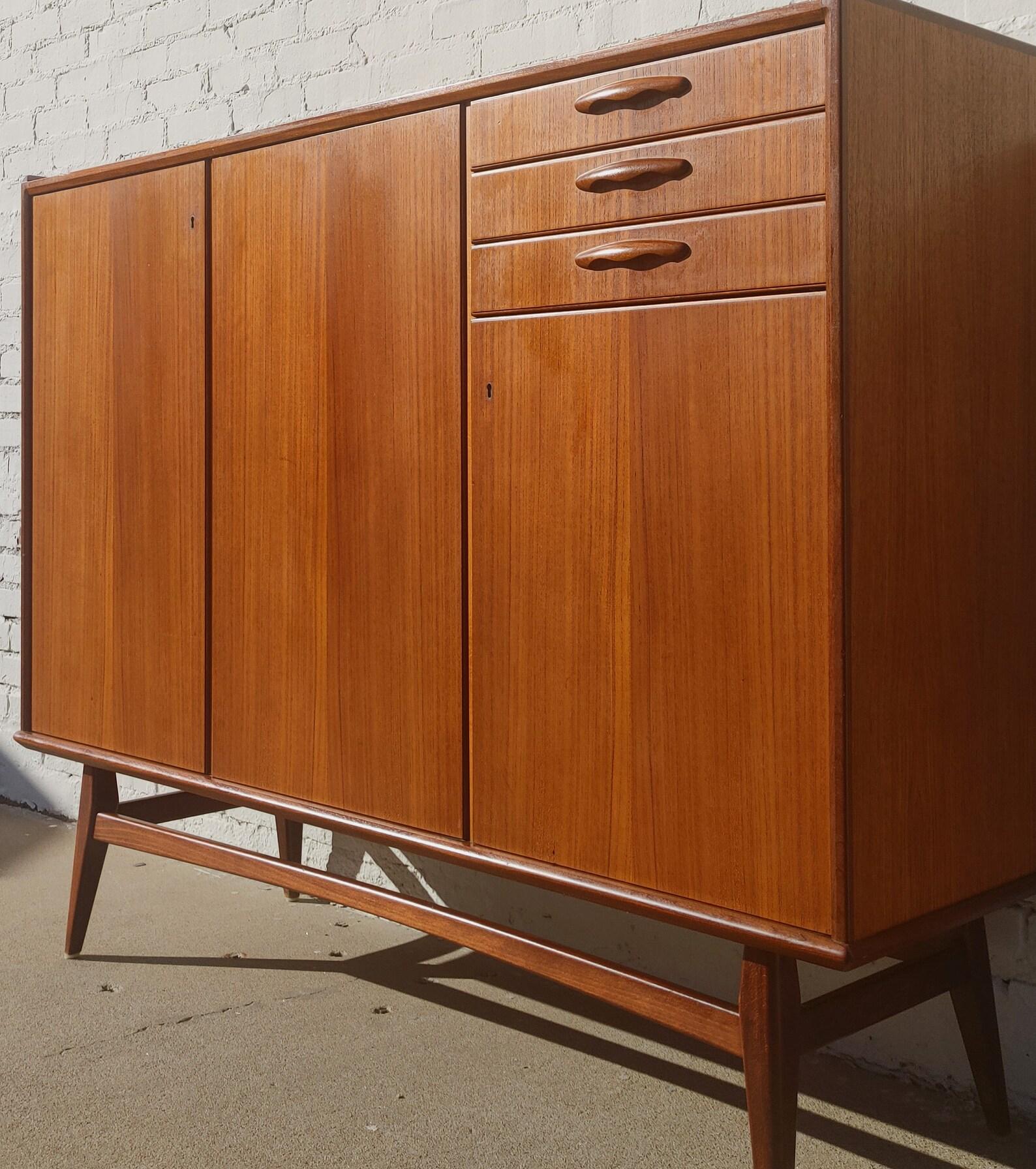 Mid Century Danish Modern Large Teak Cabinet

Above average vintage condition and structurally sound. Has some expected slight finish wear and scratching. Top has some very slight discolorations. Top has been refinished and does not have original