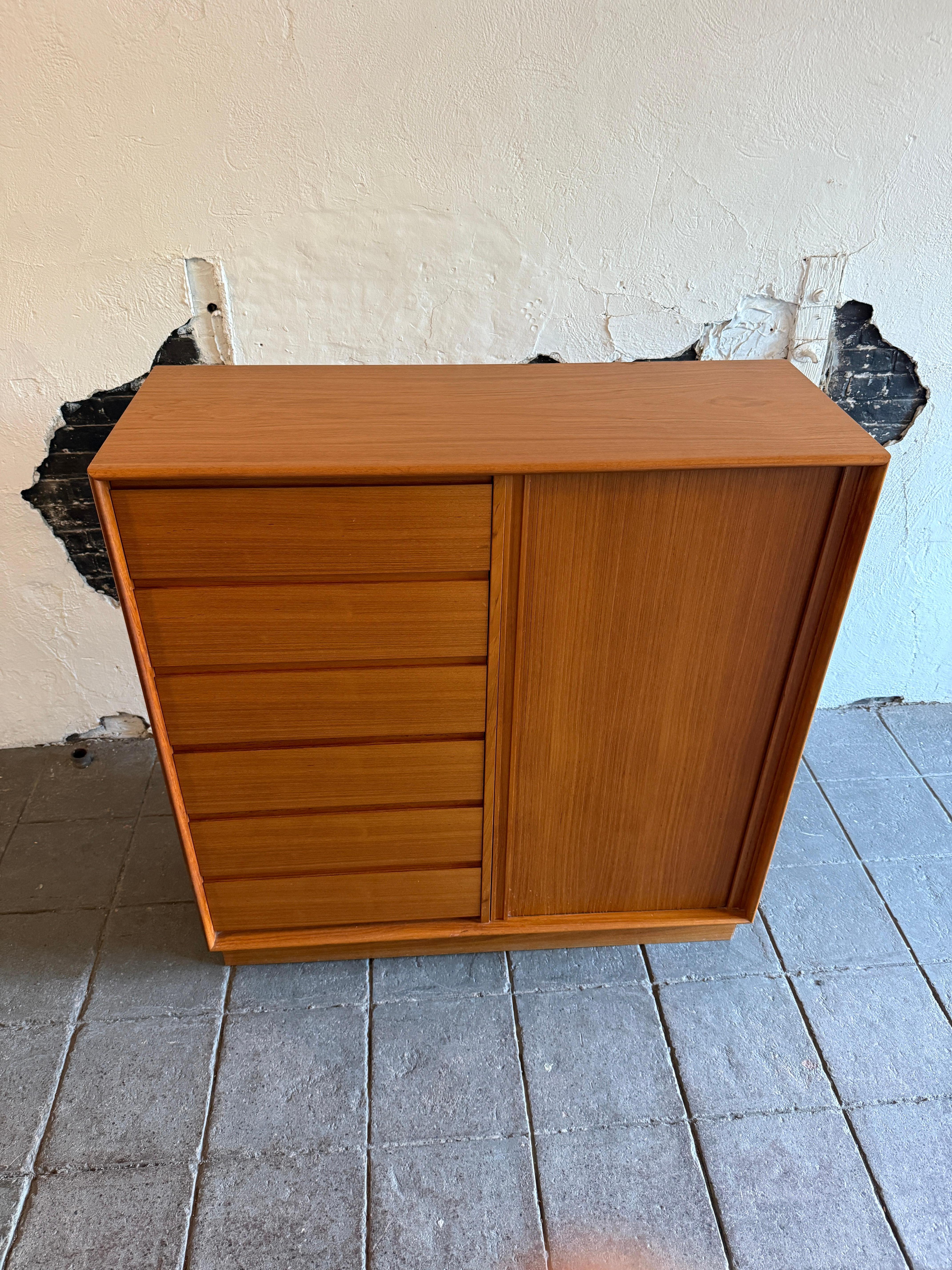 Very Clean Mid century danish modern tall wide light teak wardrobe dresser by Art furn. Simple basic Danish modern design teak 13 drawer dresser. Has 6 carved upper and lower handles with solid wood drawers with nice dovetail joints. The right hand