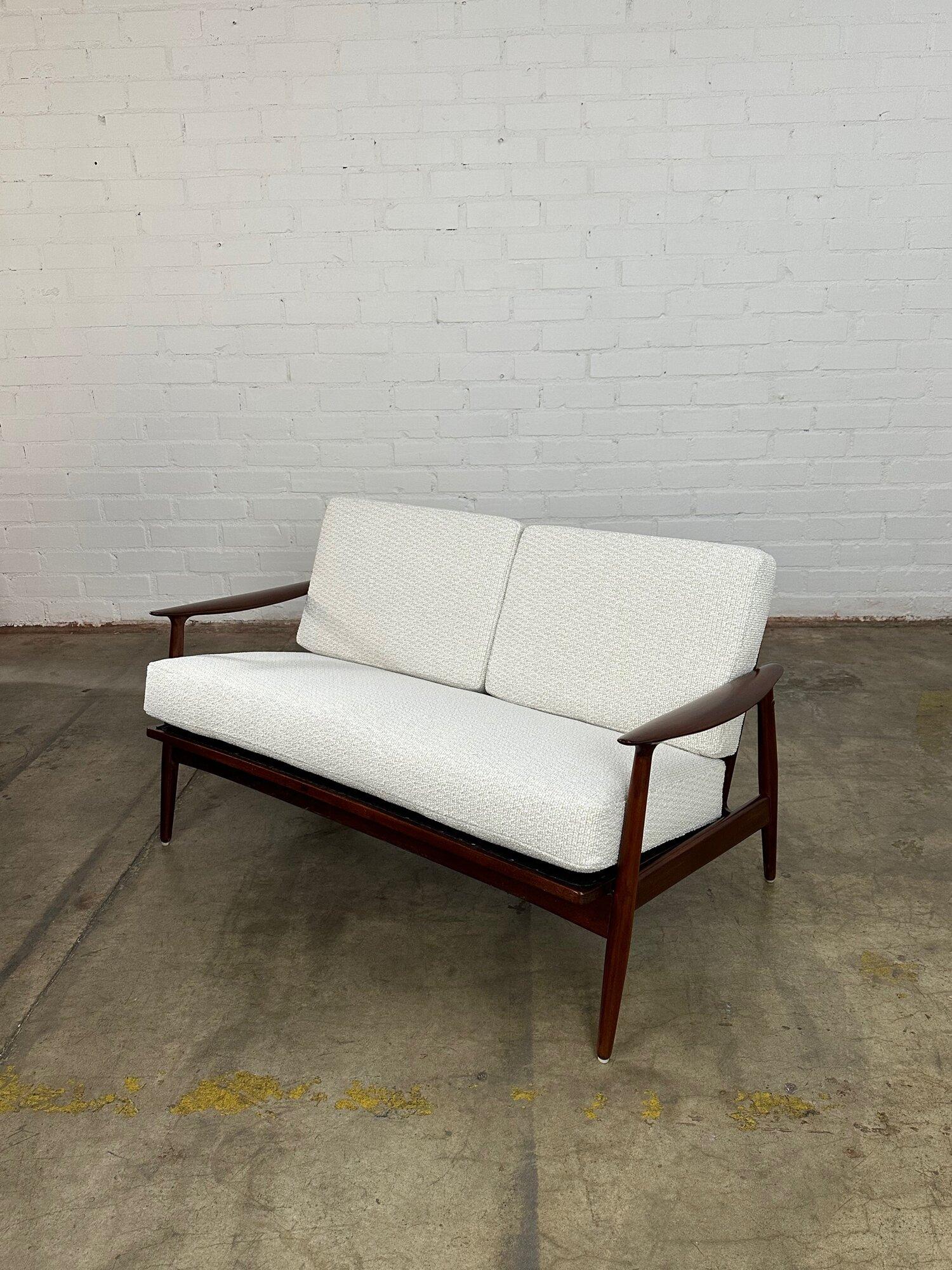 W52.5 D31 H28 SW46 SD19 SH20 AH22

Fully refinished Mid century Danish loveseat. Made out of solid teak, item is structurally sound with new foam and fabric.