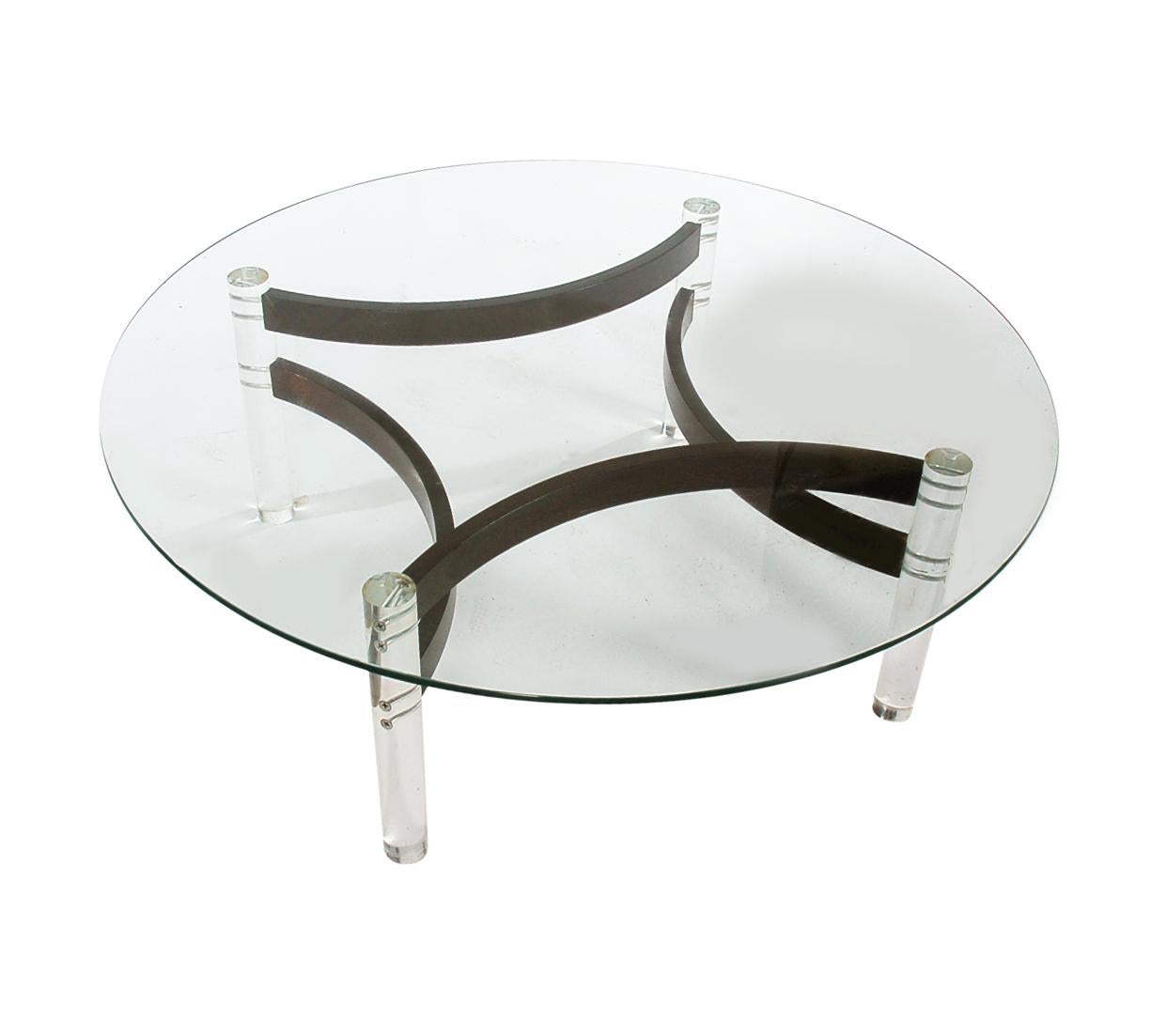 An incredible vintage coffee table circa 1970s. This table features thick solid acrylic legs, bentwood stretchers, and thick clear glass top. Very well cared for through the years.