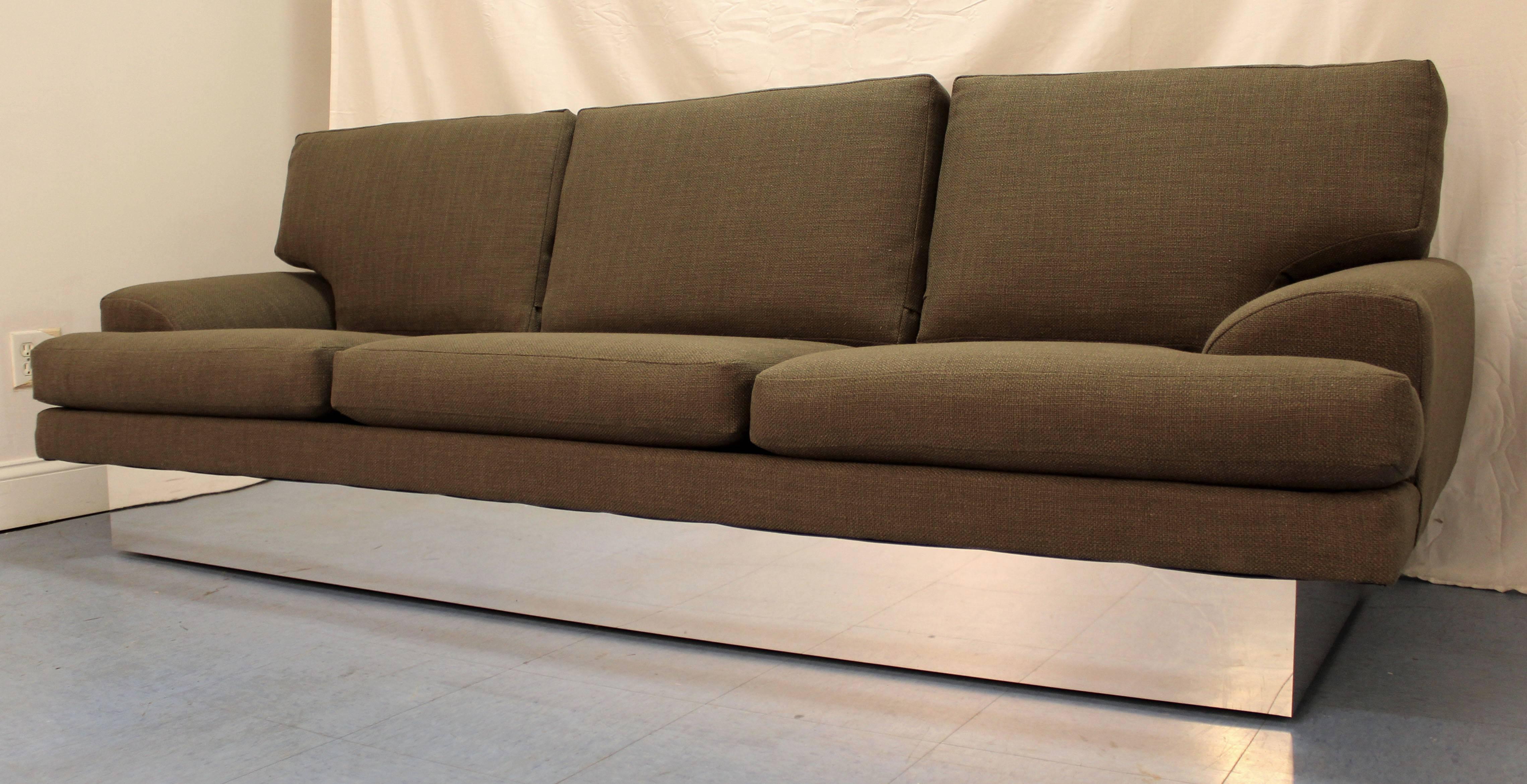 The sofa is in excellent condition and has been completely restored. The fabric color is 