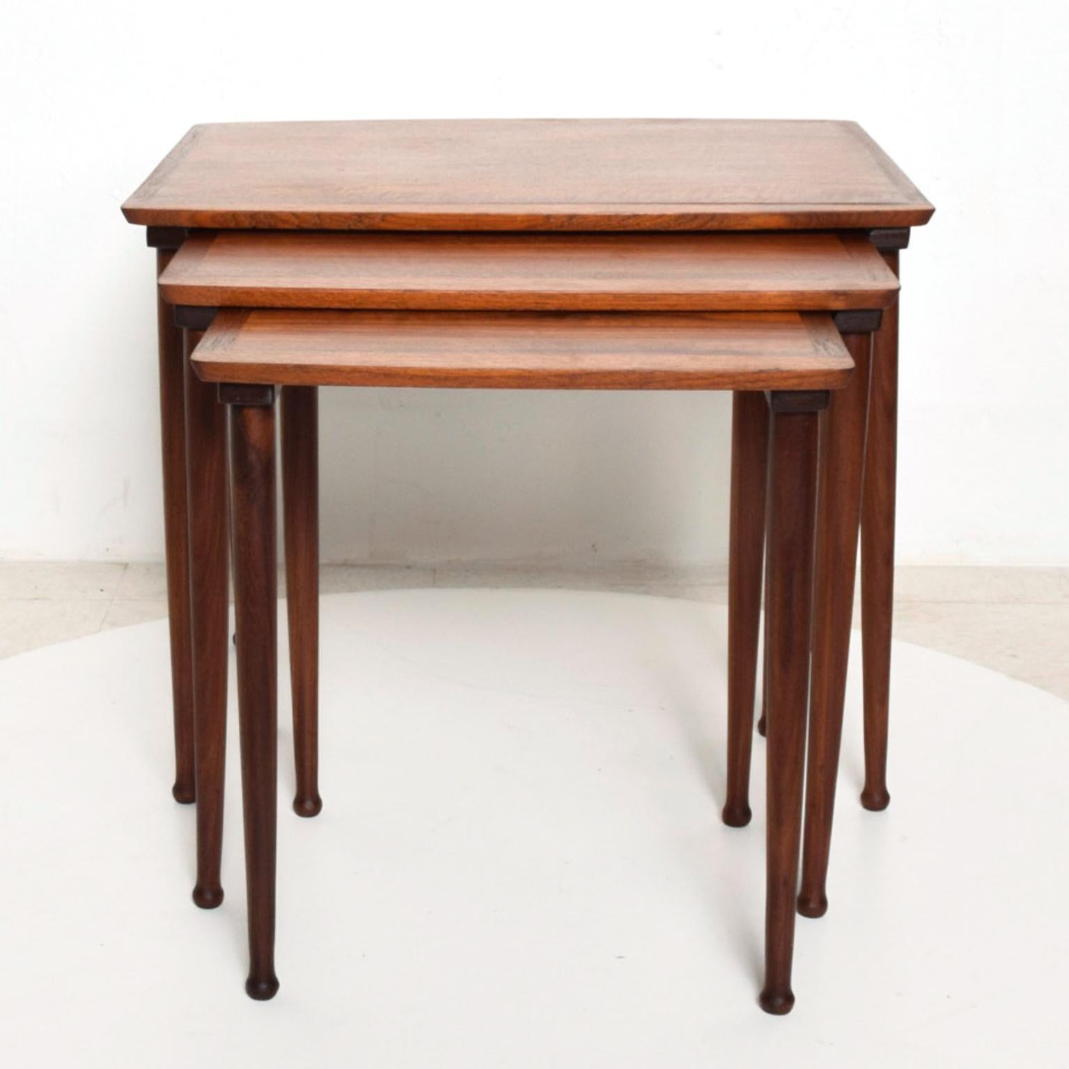 We are pleased to offer for your consideration a set of three teak nesting tables made in Denmark circa the 1960s by Mobelintarsia.

Stamped underneath with Danish modern control label. 

Legs can be removed for safe and easy