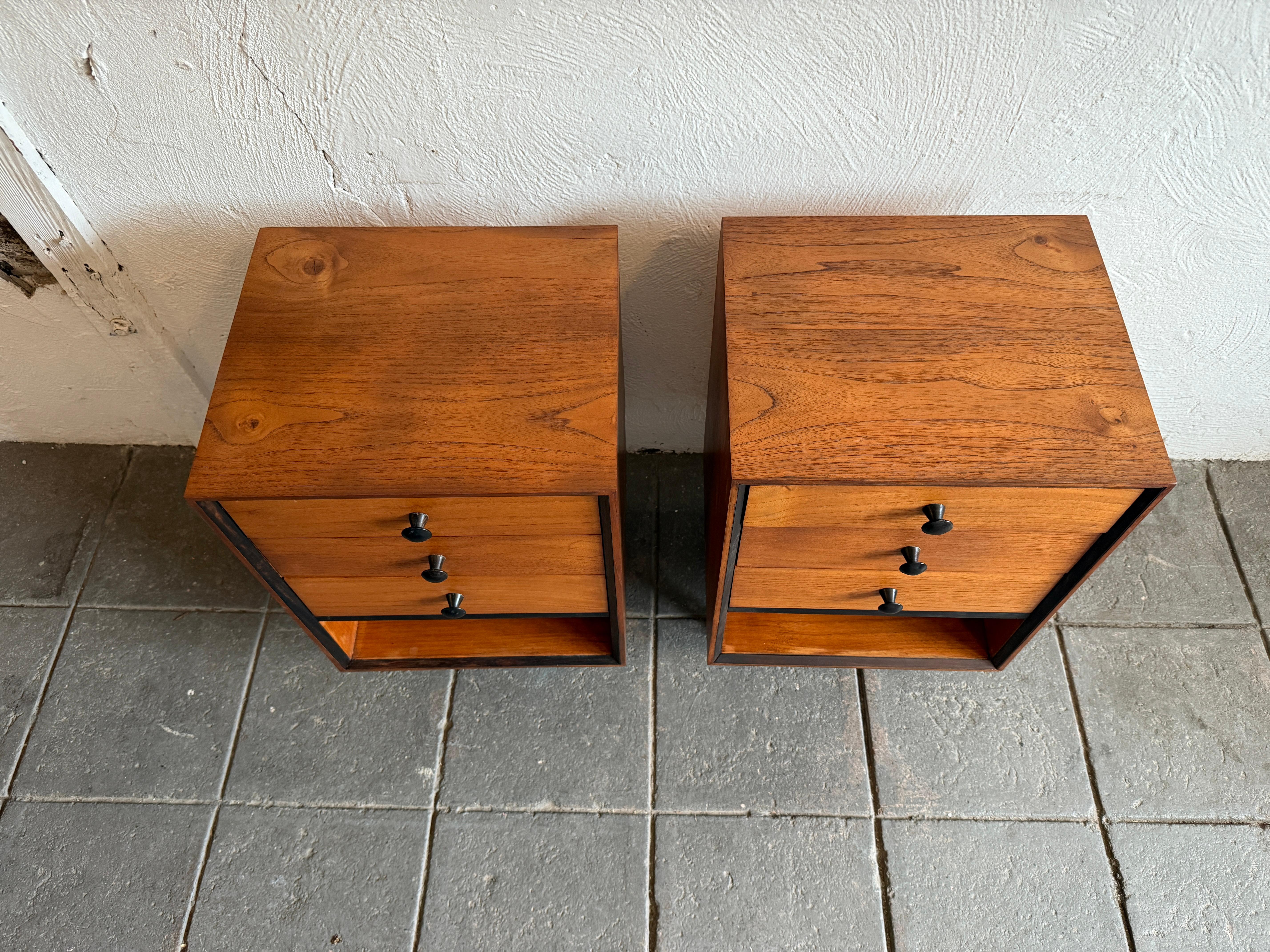 Mid century Danish modern narrow 3 drawer teak nightstands. Unique pair of 3 drawer nightstands with beautiful wood grain and lower cubby area. Sits on 4 tapered wood legs with round wood knob pulls. Very good vintage condition- ready for use.